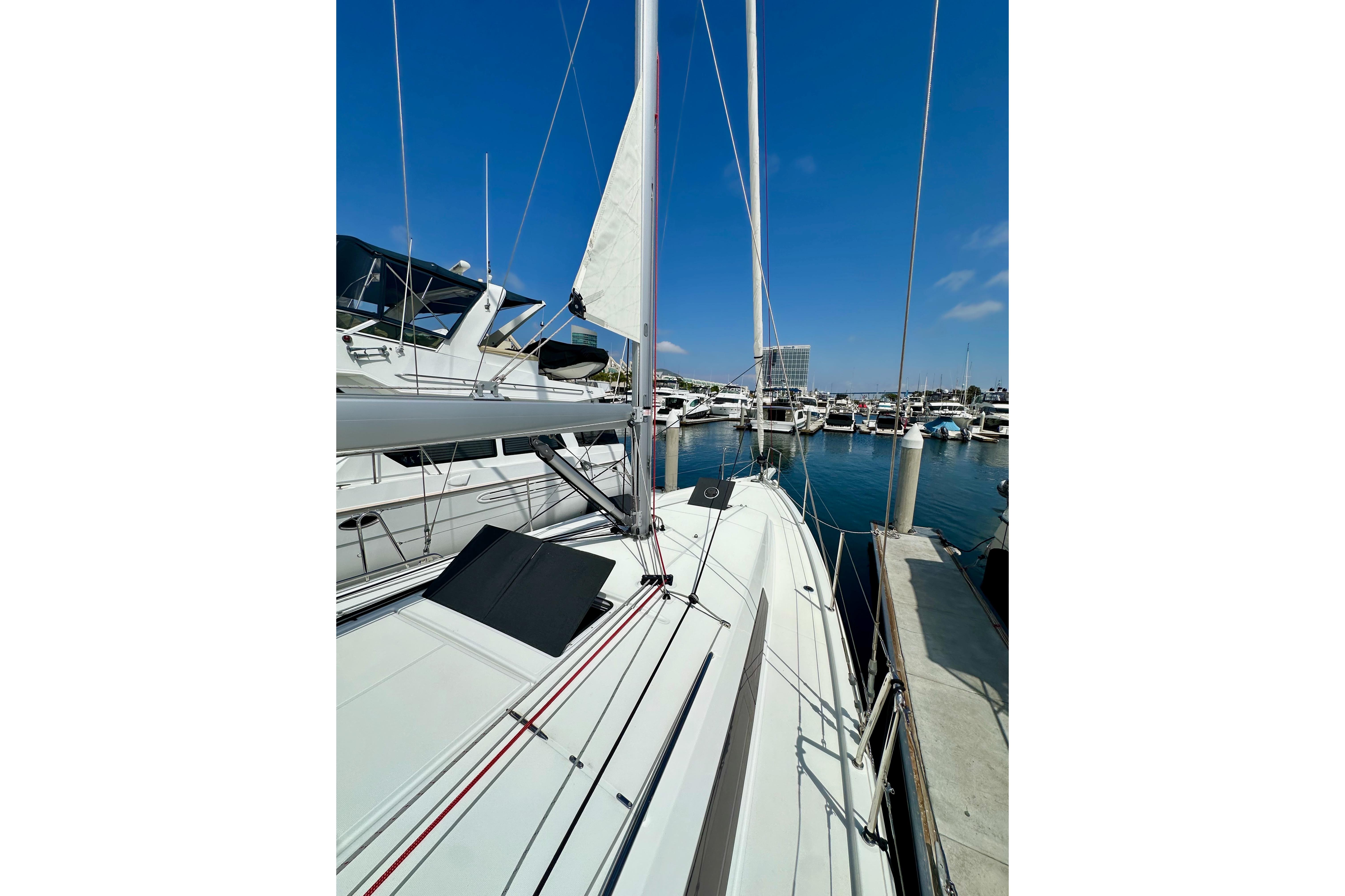 2024 Jeanneau Sun Odyssey 410 sailboat docked in a marina under clear blue skies.