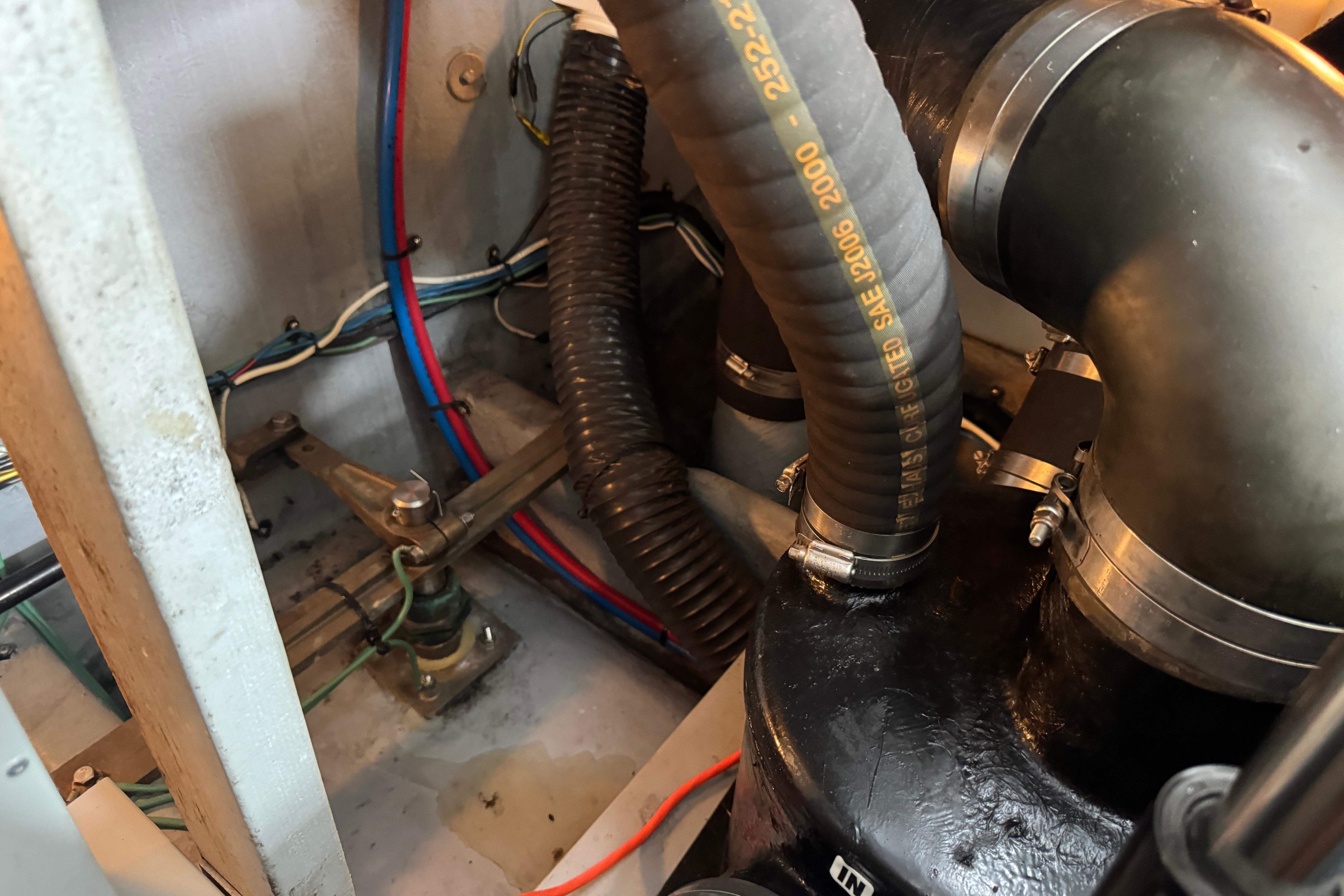 Engine compartment of a 2001 Sea Ray 380 Sundancer, showing hoses and wiring.
