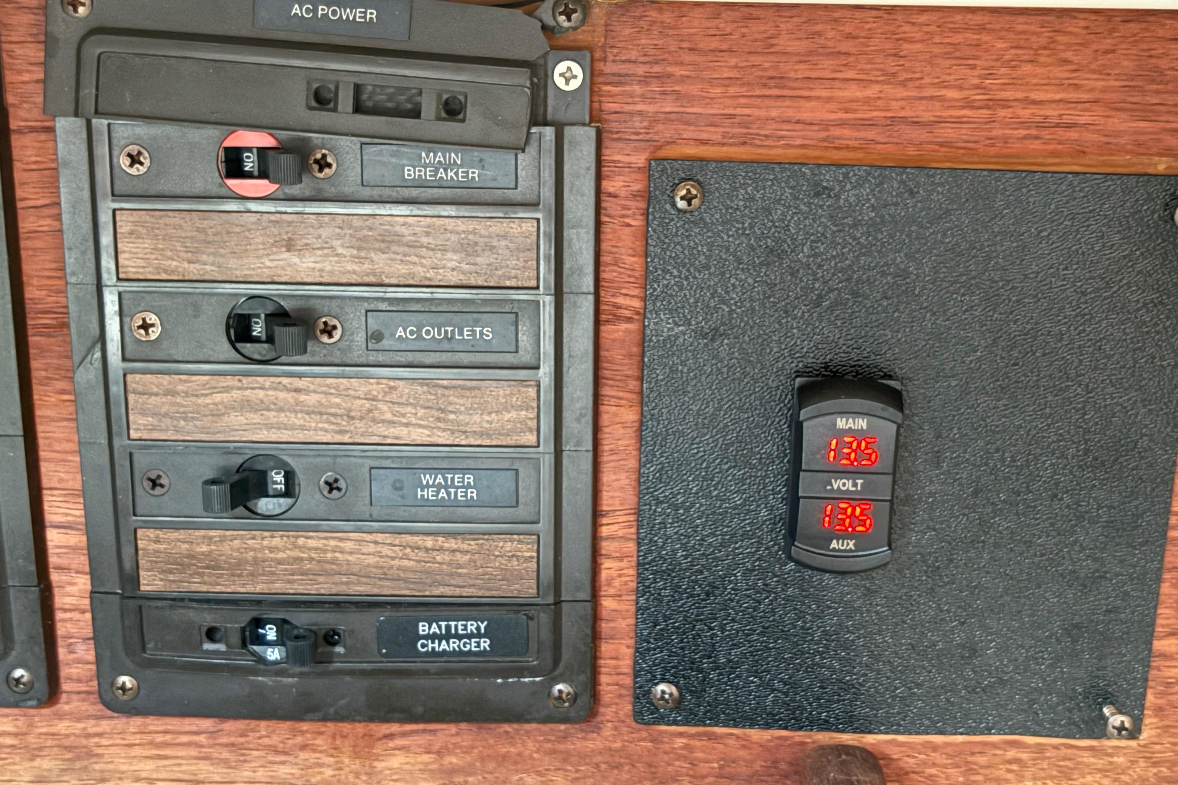 Electrical panel of a 1981 Sabre 31 boat with voltage display and switches.