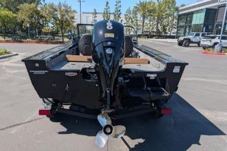 2026 Tracker Targa V-18 WT boat, rear view with outboard motor, parked outdoors.