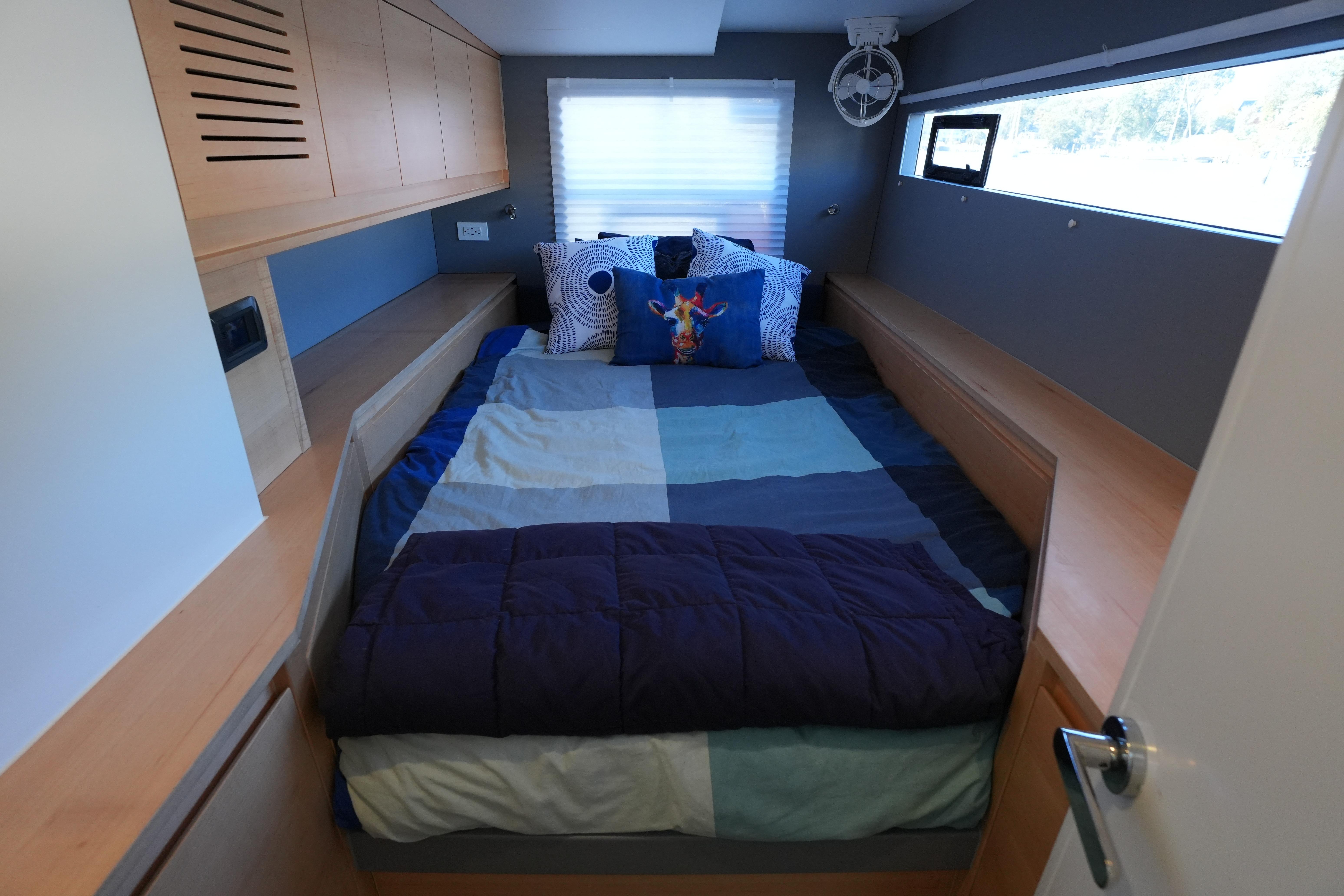 Cozy bedroom in 2024 Balance 442 yacht with modern design and colorful bedding.