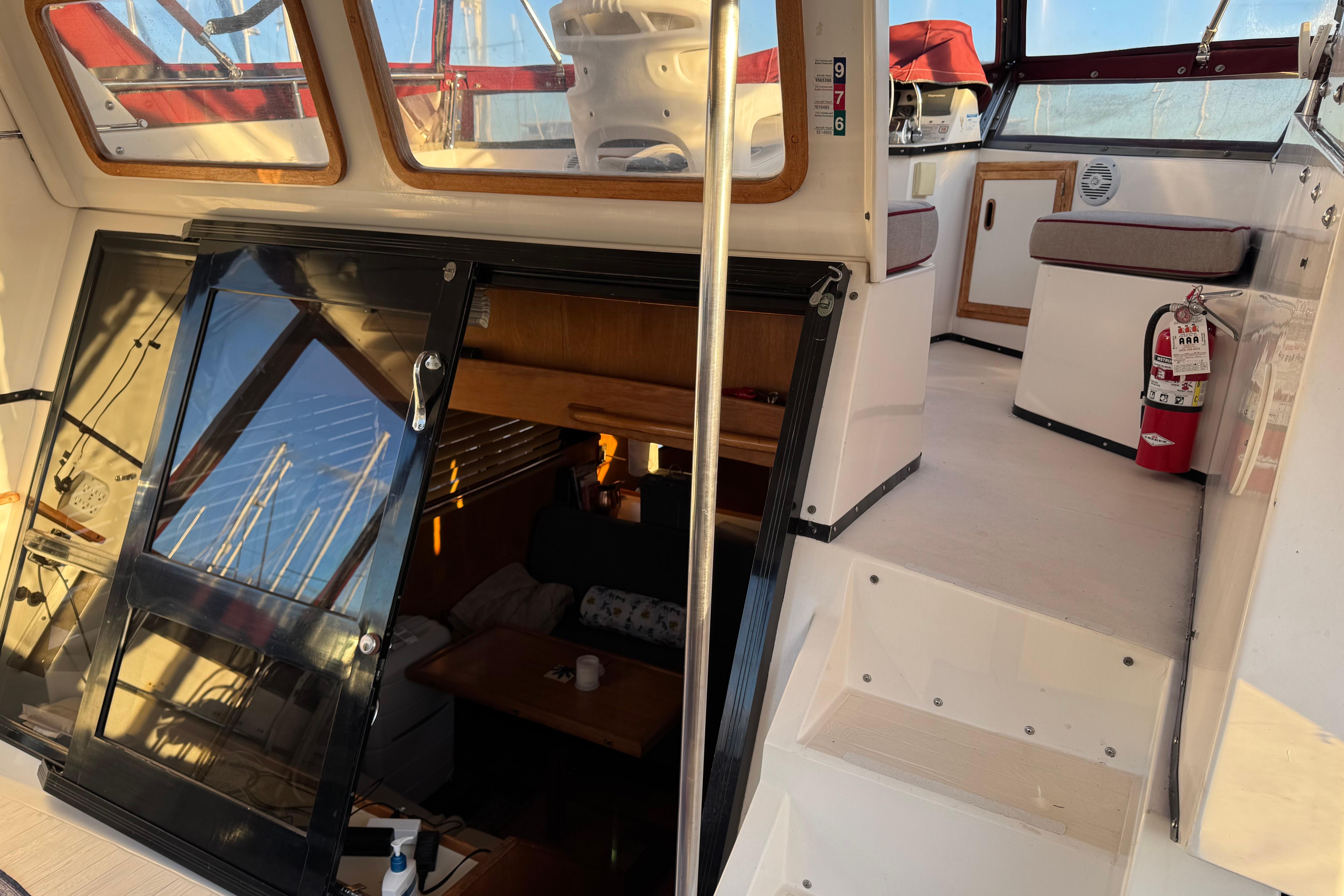 Interior view of a 1987 President 37 yacht, featuring stairs and seating area.