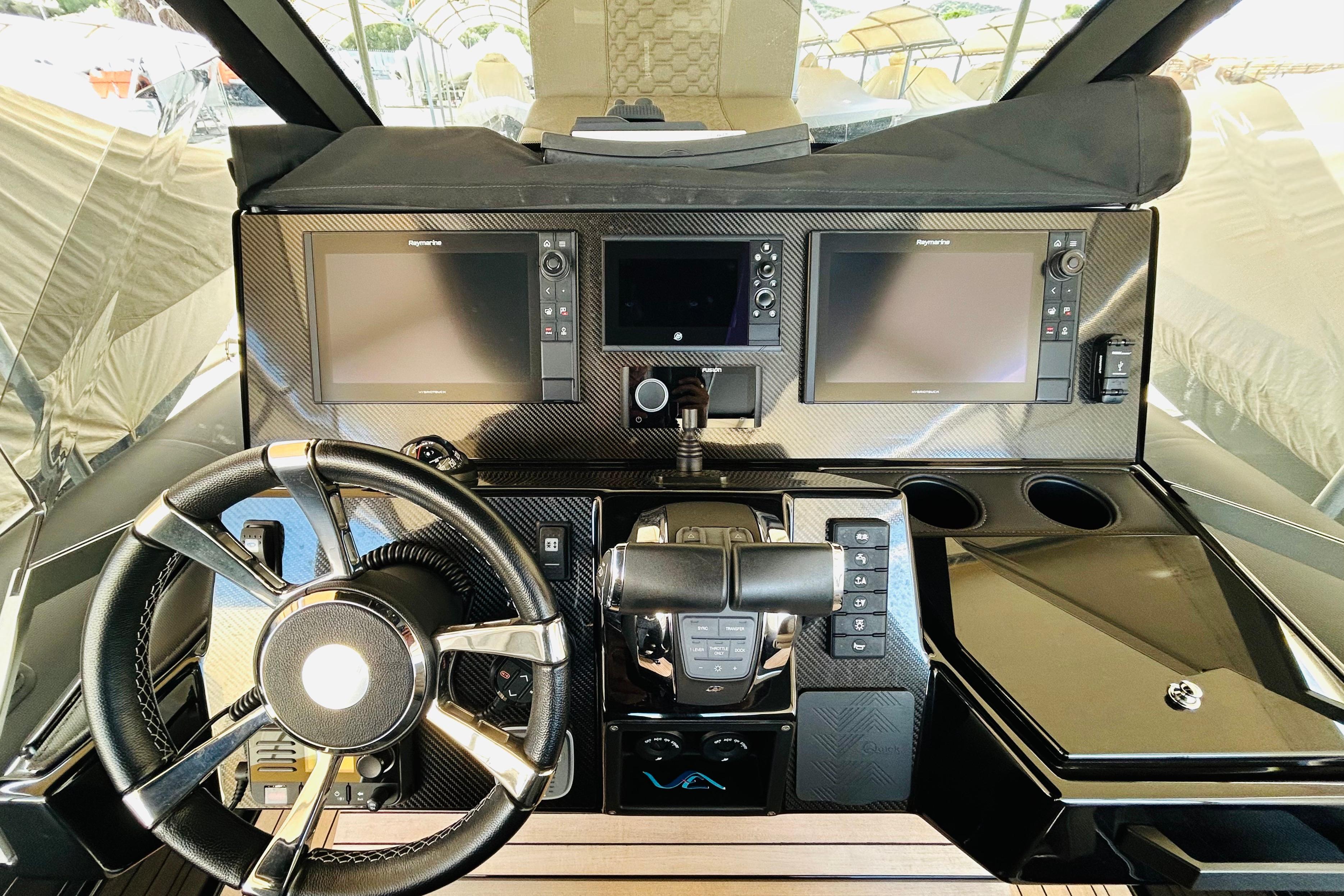 Cockpit of 2022 Technohull 38 Grand Sport with advanced navigation displays and controls.