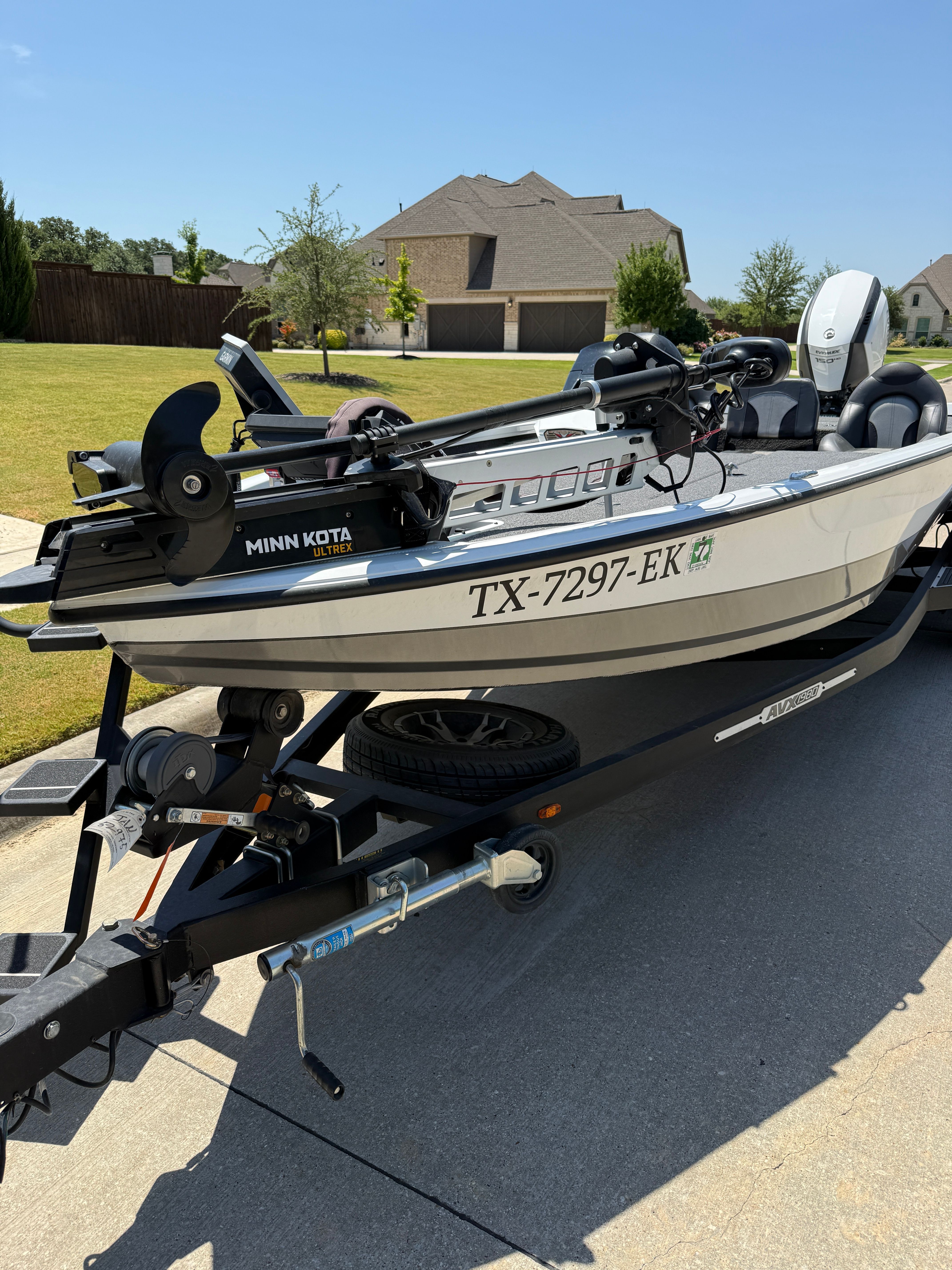 A 2019 Vexus AVX1980 boat on a trailer in a residential area.