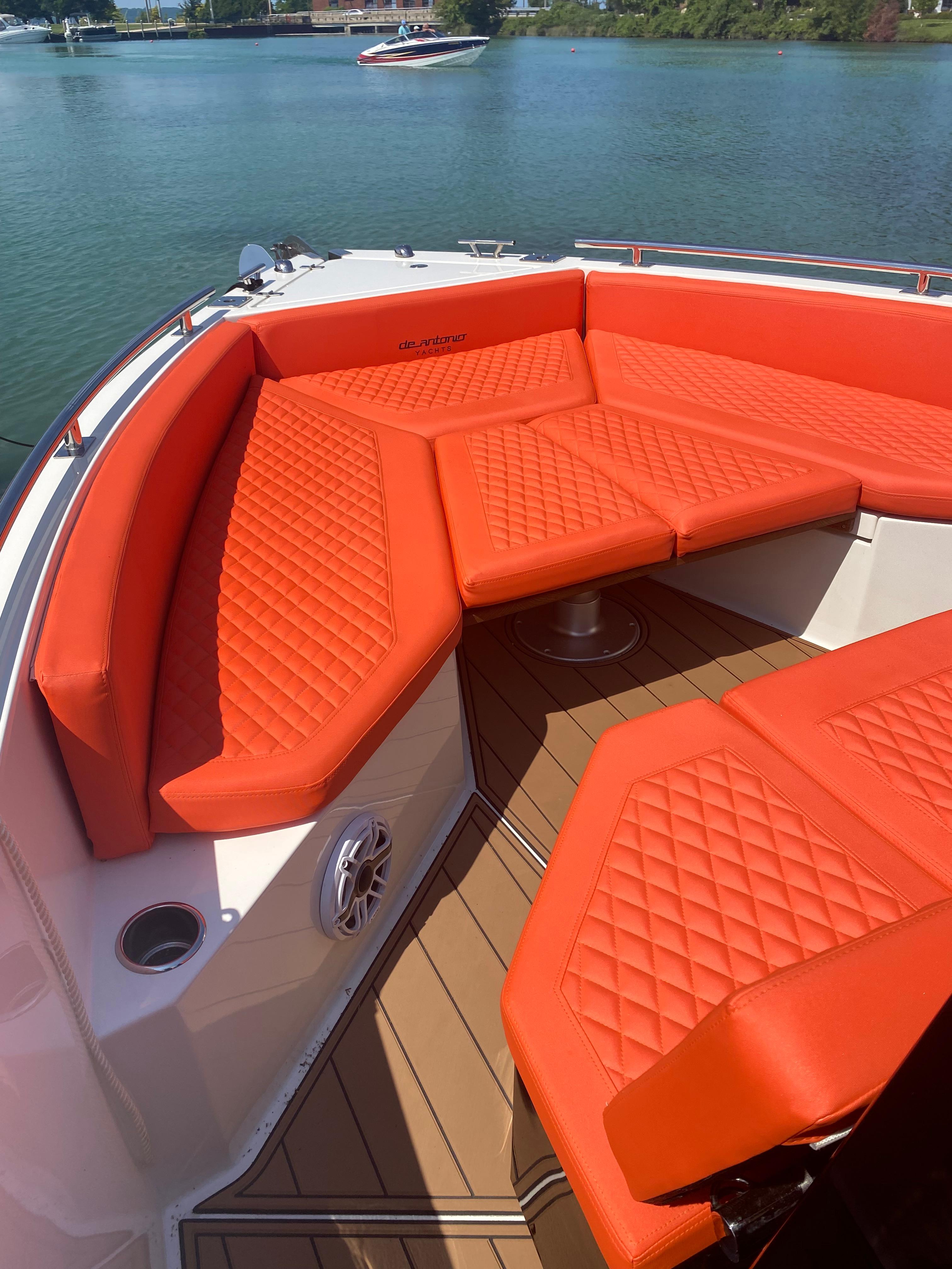 2020 De Antonio Yachts D 28 with orange cushioned seating on deck.