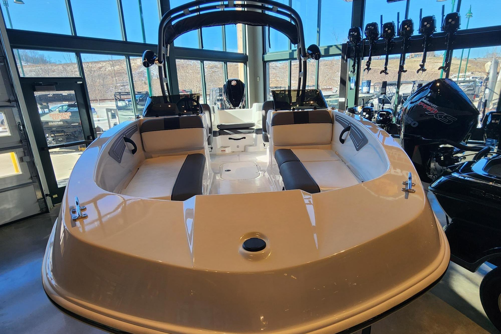 2026 Tahoe T21 boat displayed in a showroom with modern interior design.