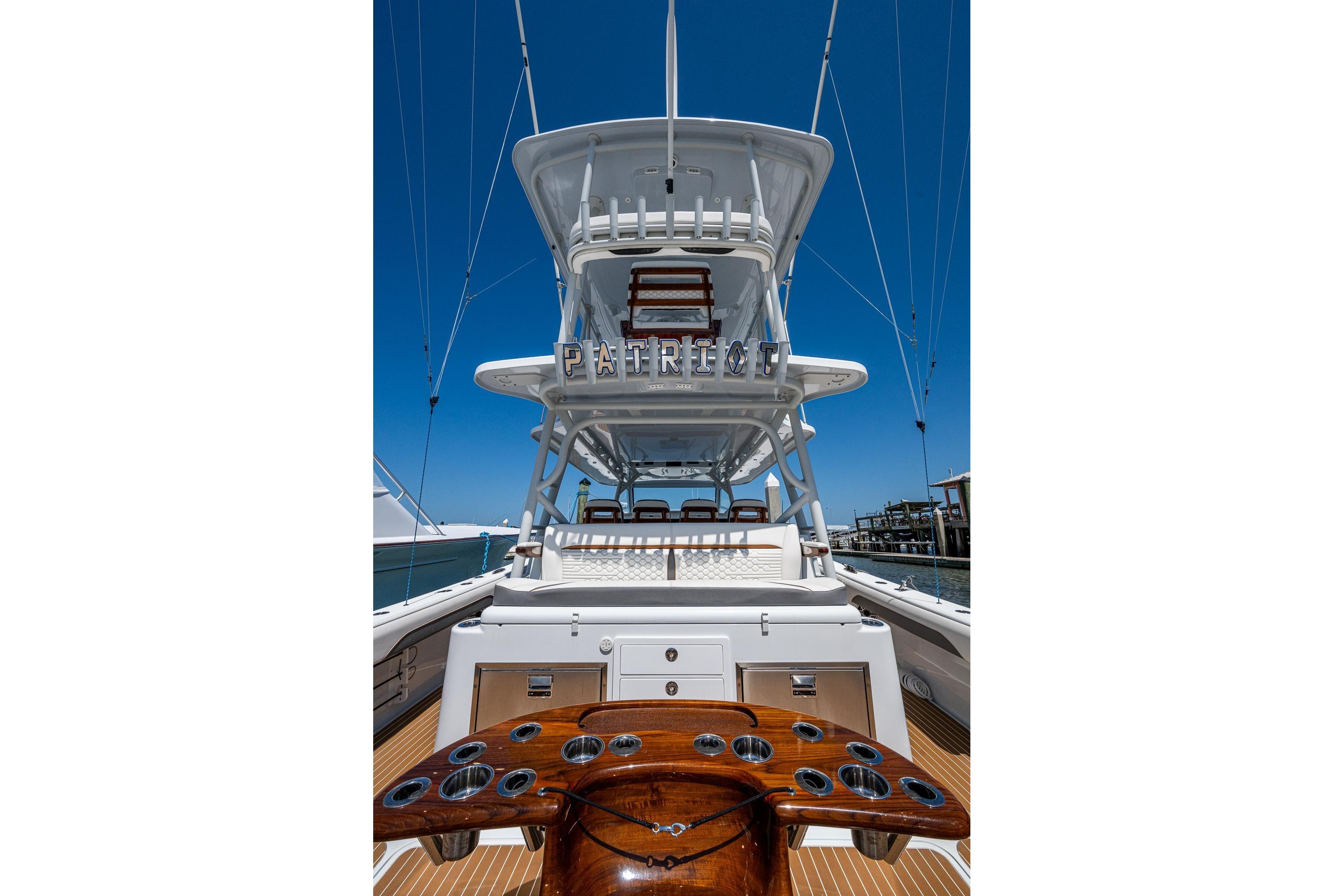 2022 Yellowfin 54 Offshore boat with tower, docked under clear blue sky.