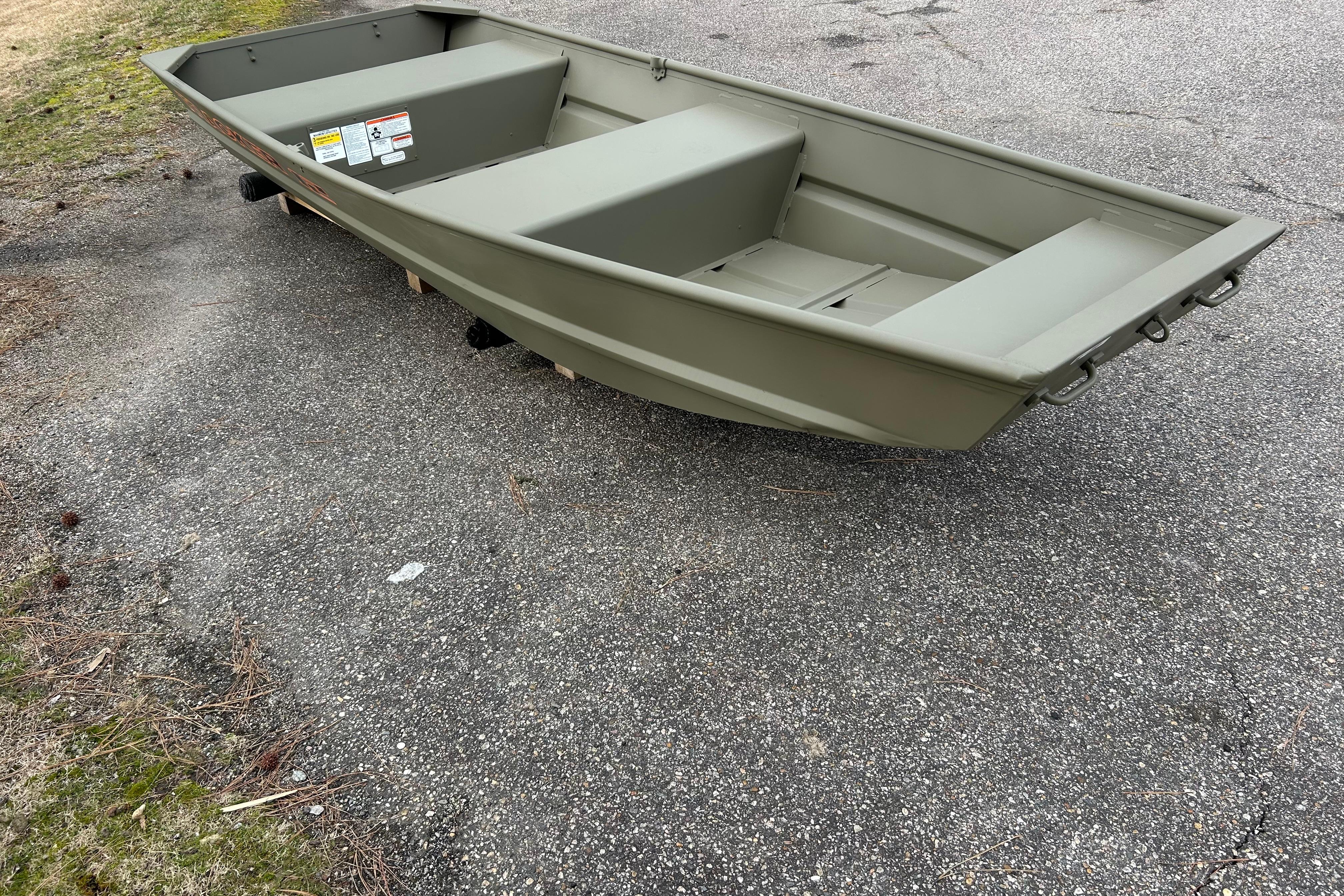 2026 Tracker Grizzly 12 Jon boat on pavement, showcasing its sturdy design.