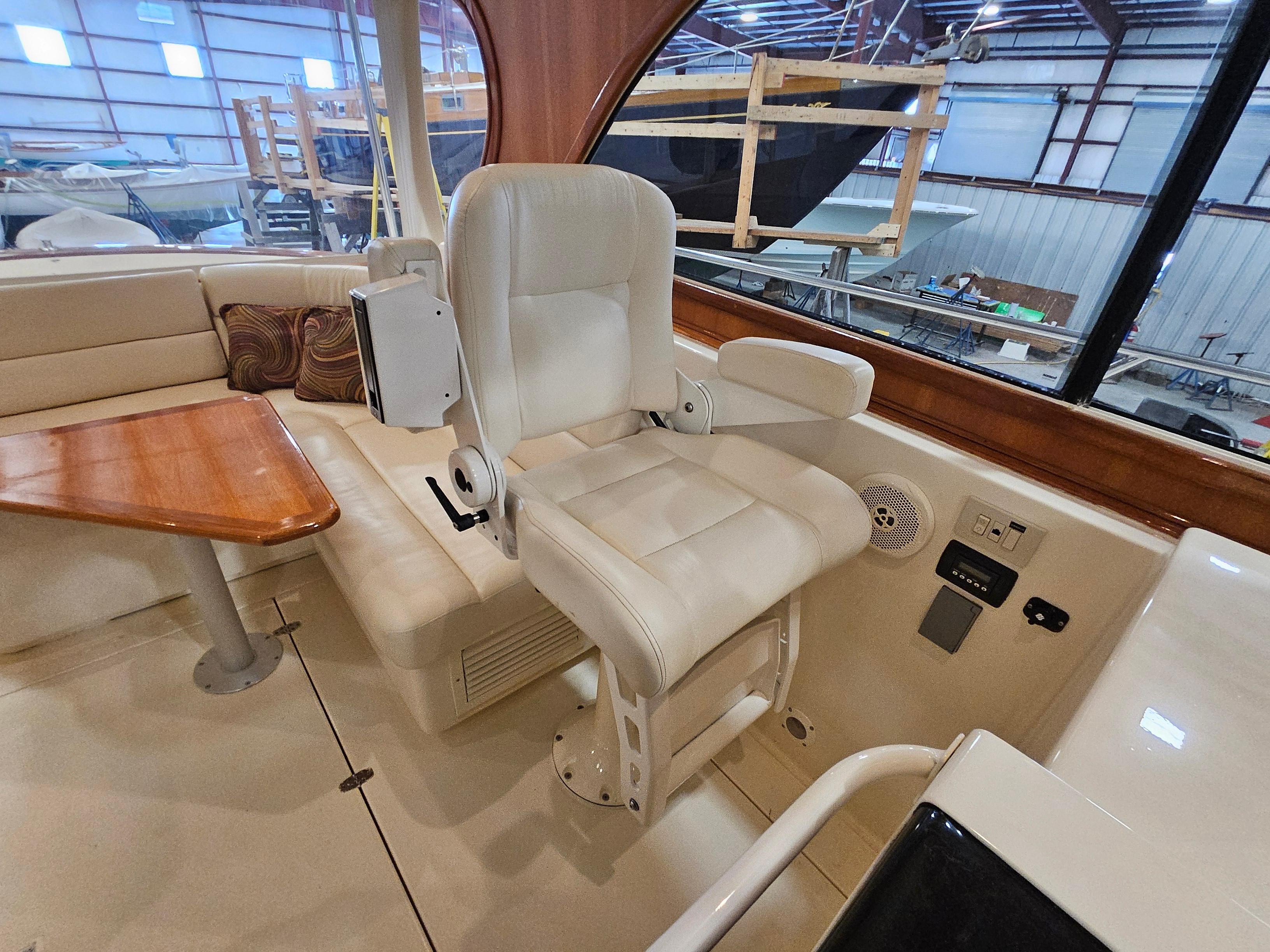 Captain's chair and seating area inside 2003 Legacy 40 Hardtop Express yacht.