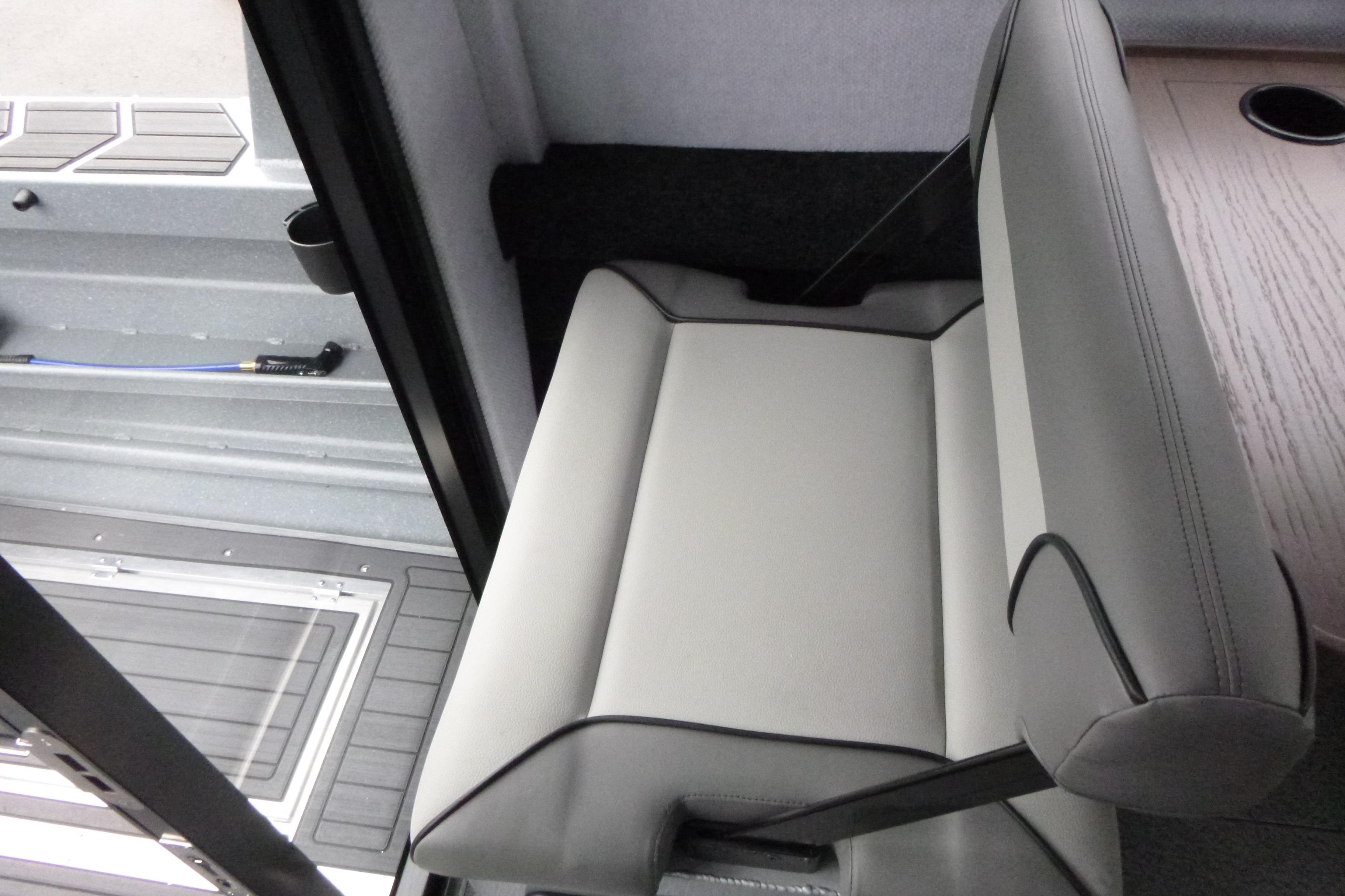 Interior seating of 2026 KingFisher 25 XAC boat, featuring sleek gray upholstery.