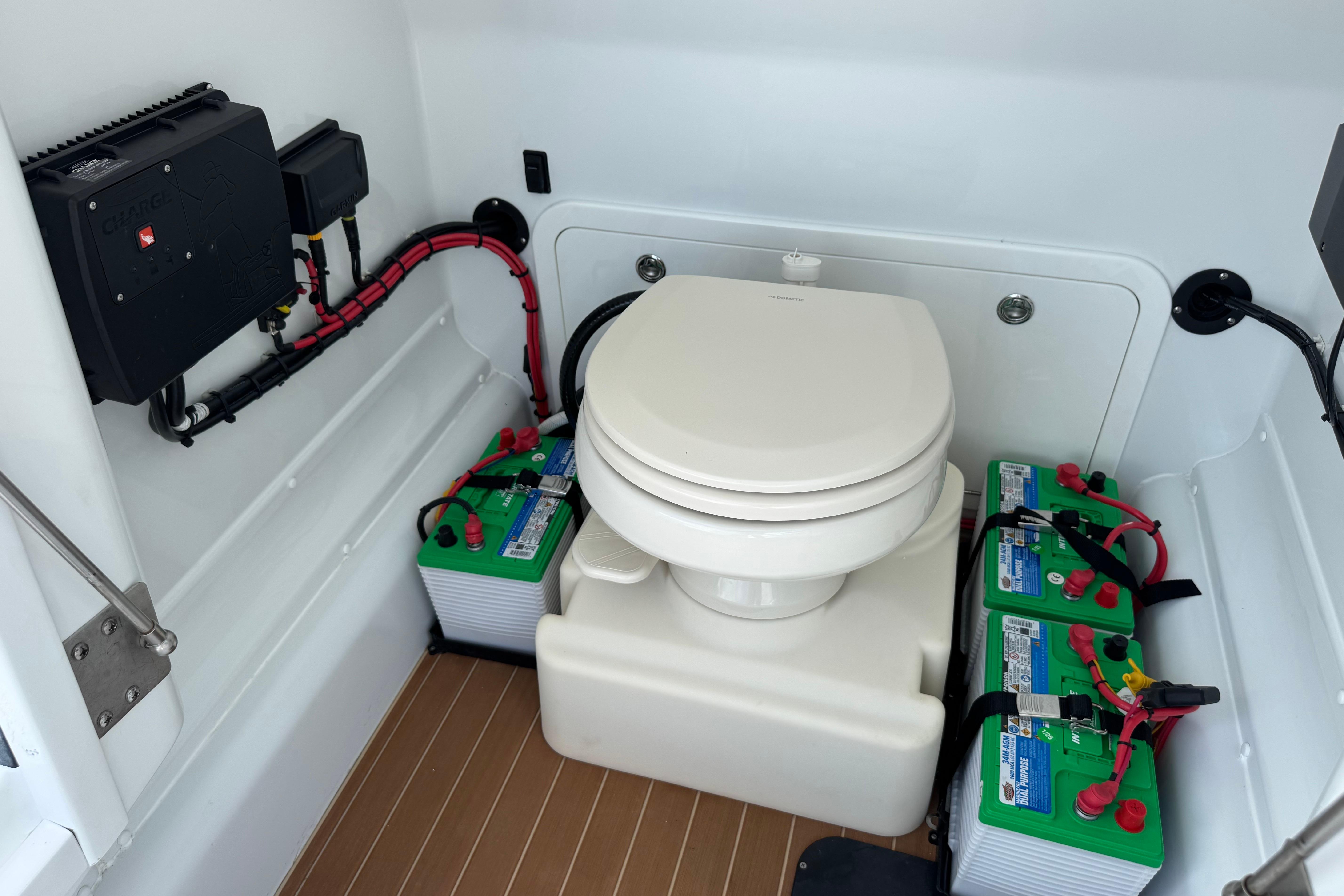 2022 Yellowfin 32 Offshore boat interior with toilet and battery setup.