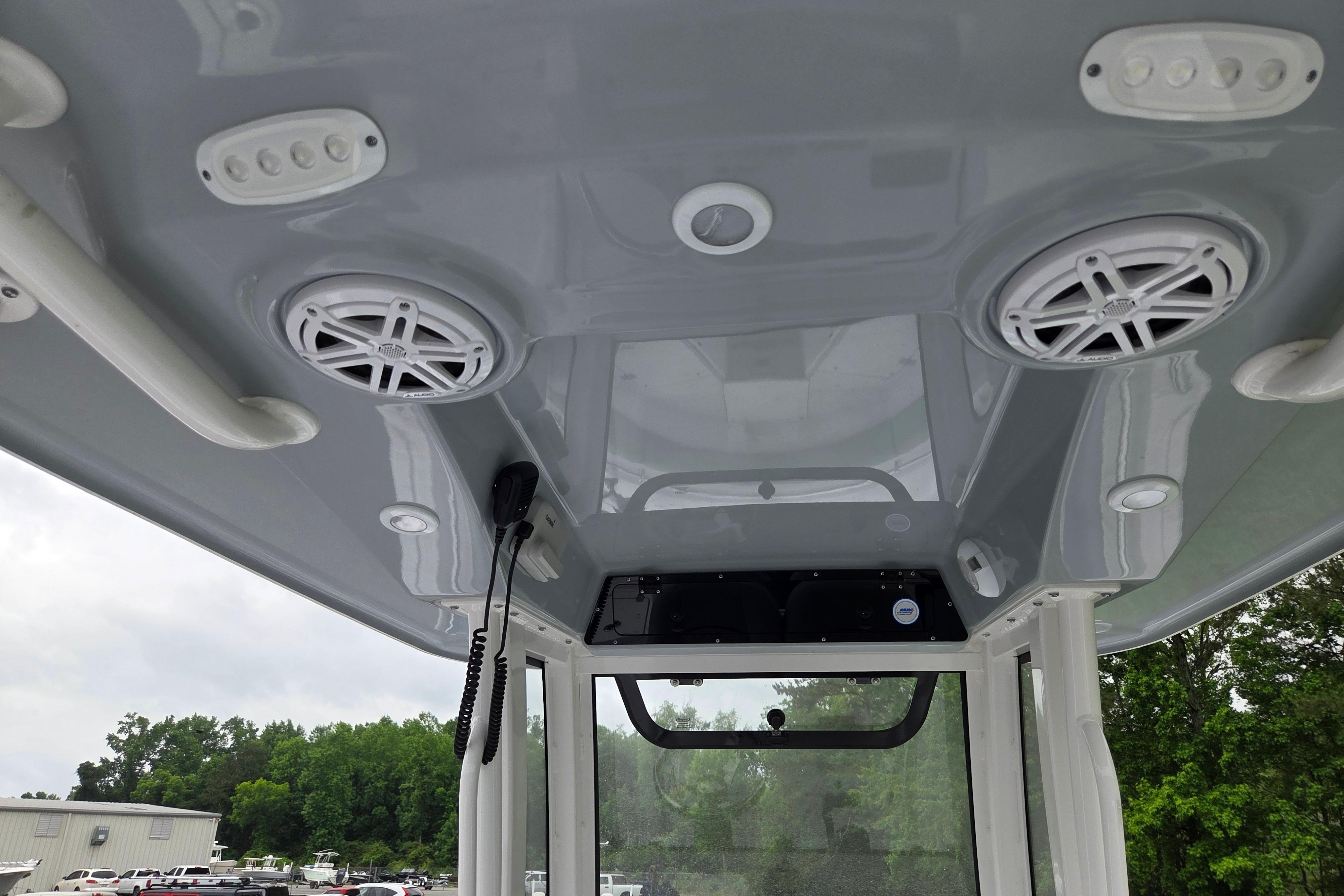 2026 Sportsman Open 232 Center Console boat interior with speakers and controls.