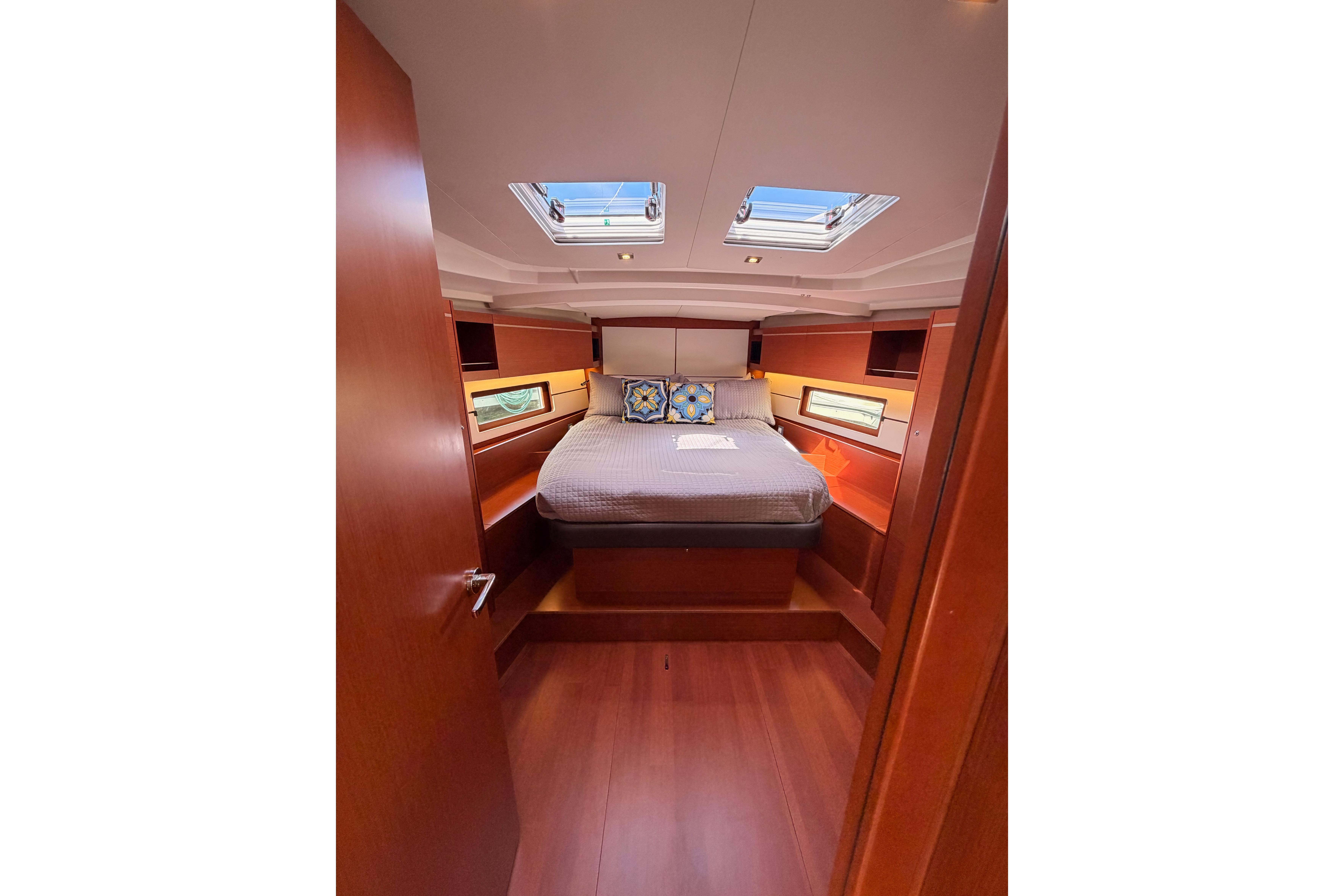 Luxurious cabin interior of 2020 Beneteau Oceanis 46.1 yacht with skylights and cozy bedding.