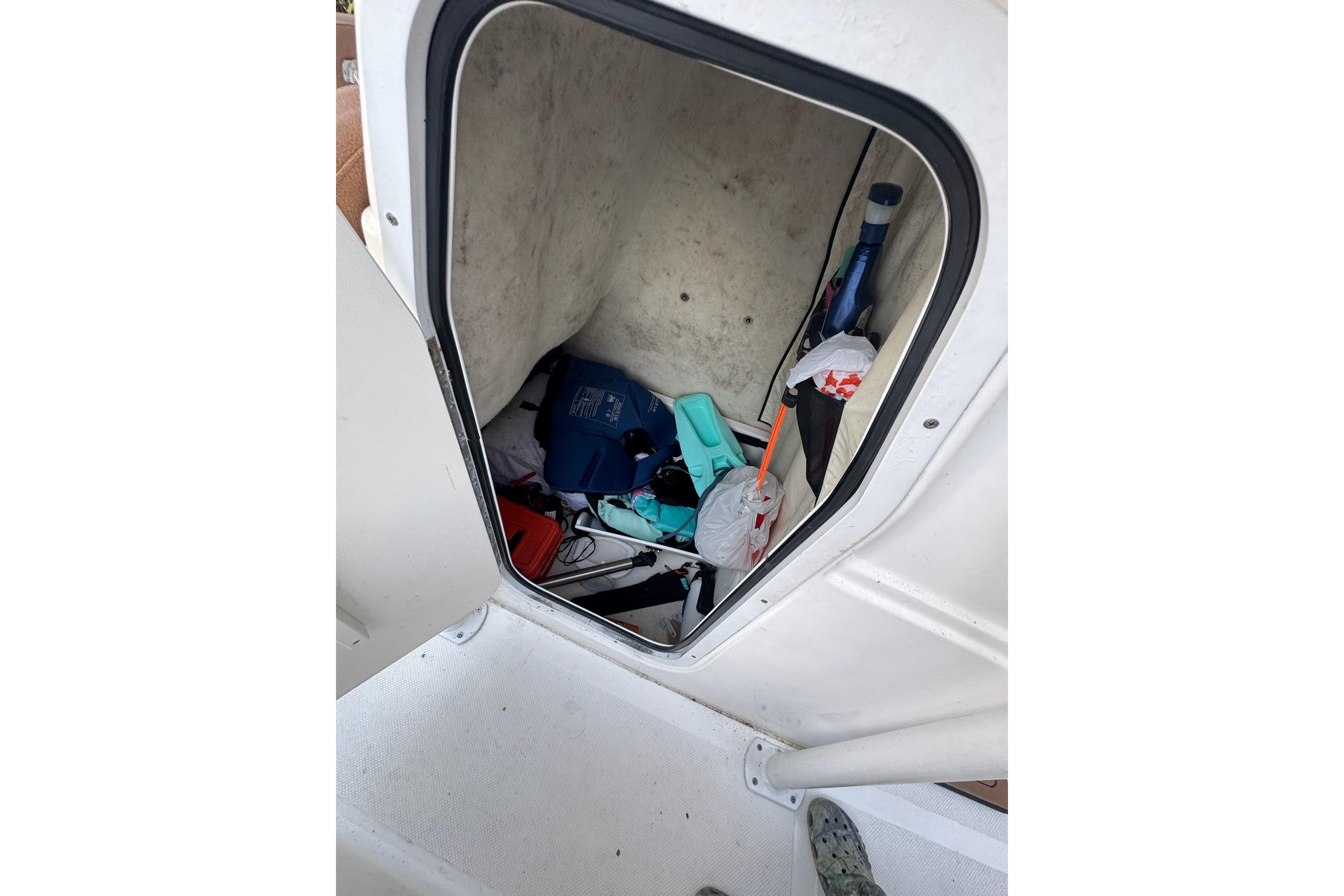 Storage compartment of a 2013 Sea Fox 246 Commander boat, containing various items.