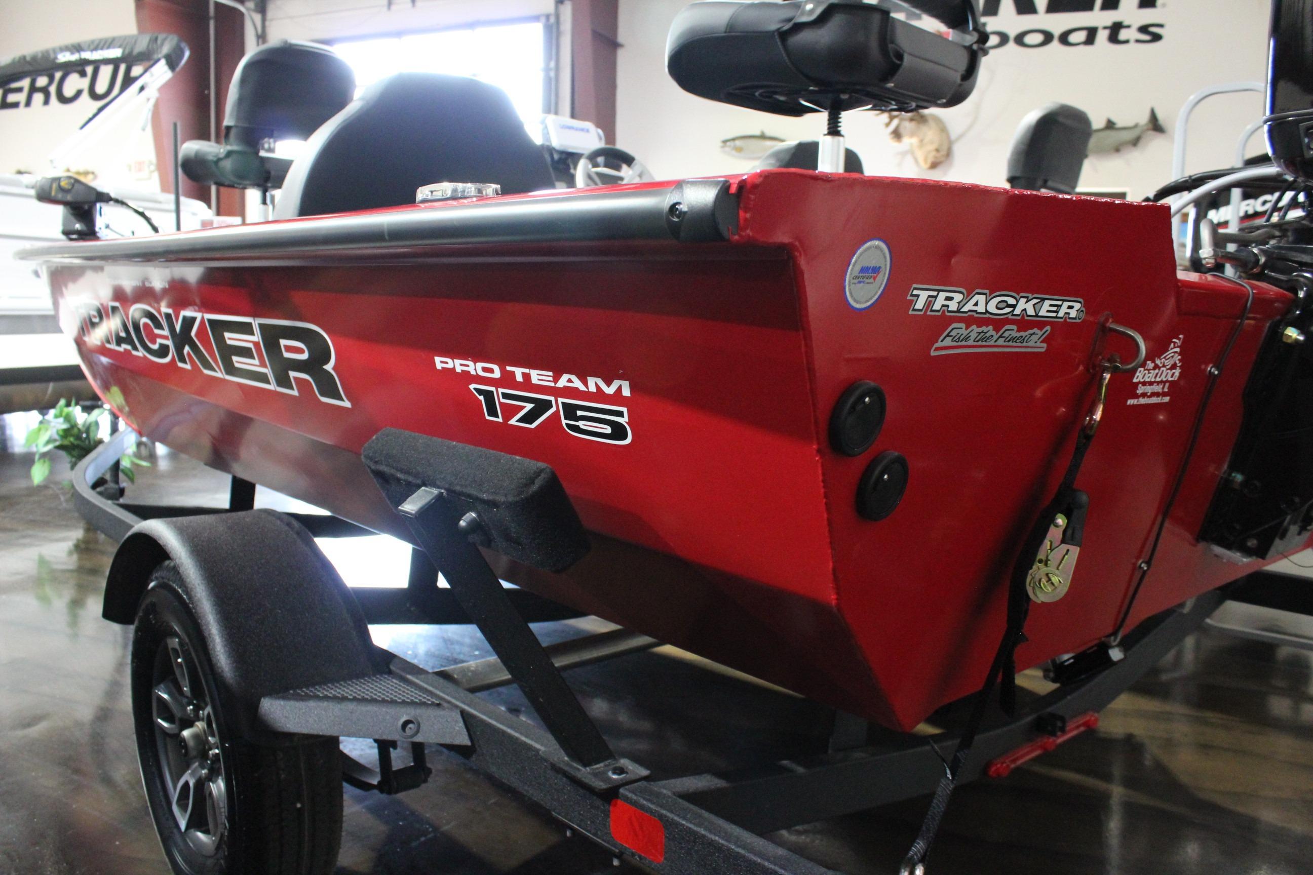 2026 Tracker Pro Team 175 boat in showroom, red exterior, on trailer.