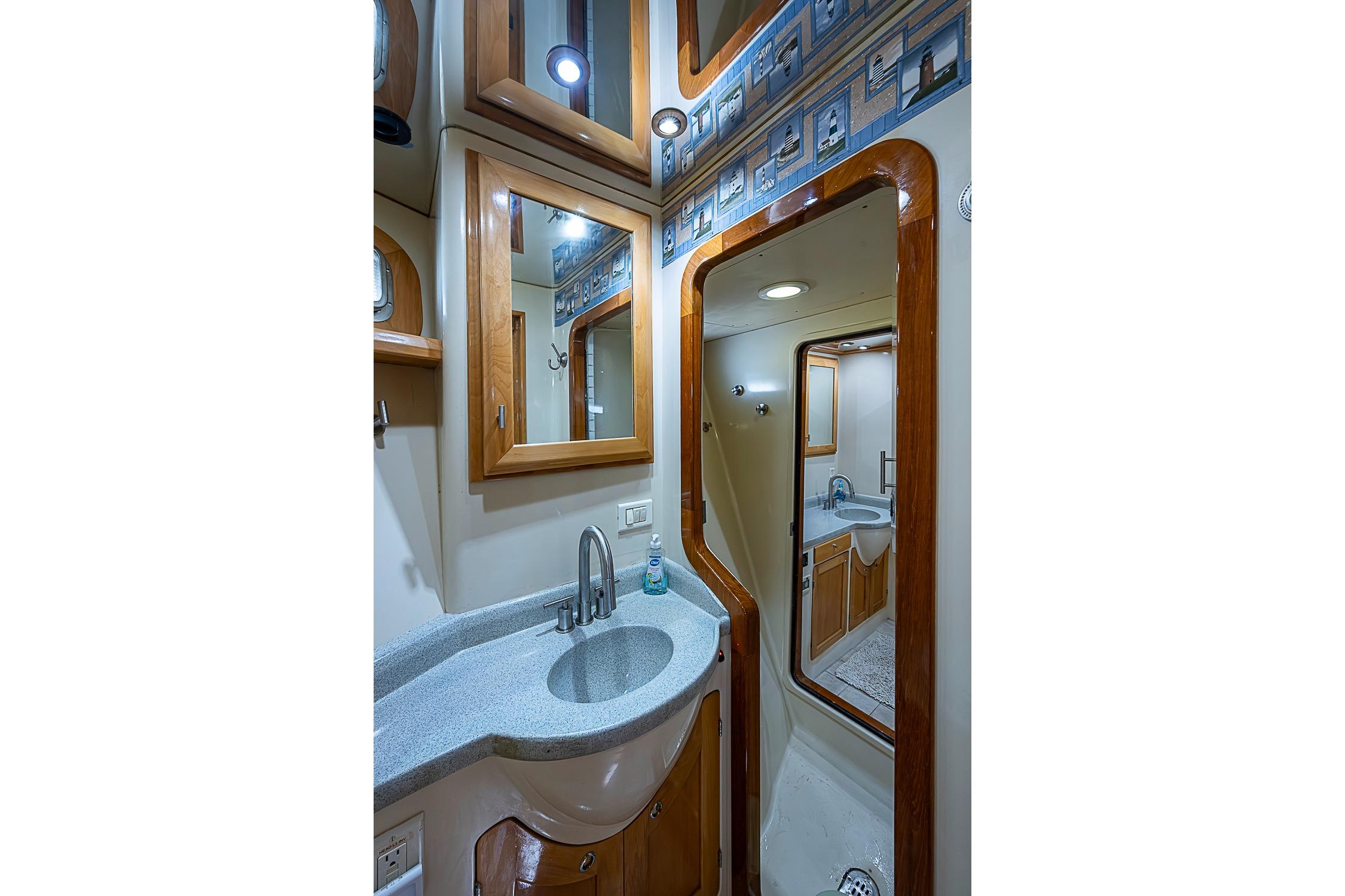 Luxurious bathroom interior of 2003 Magna Marine Nova Scotia 47 yacht, featuring elegant wood accents.