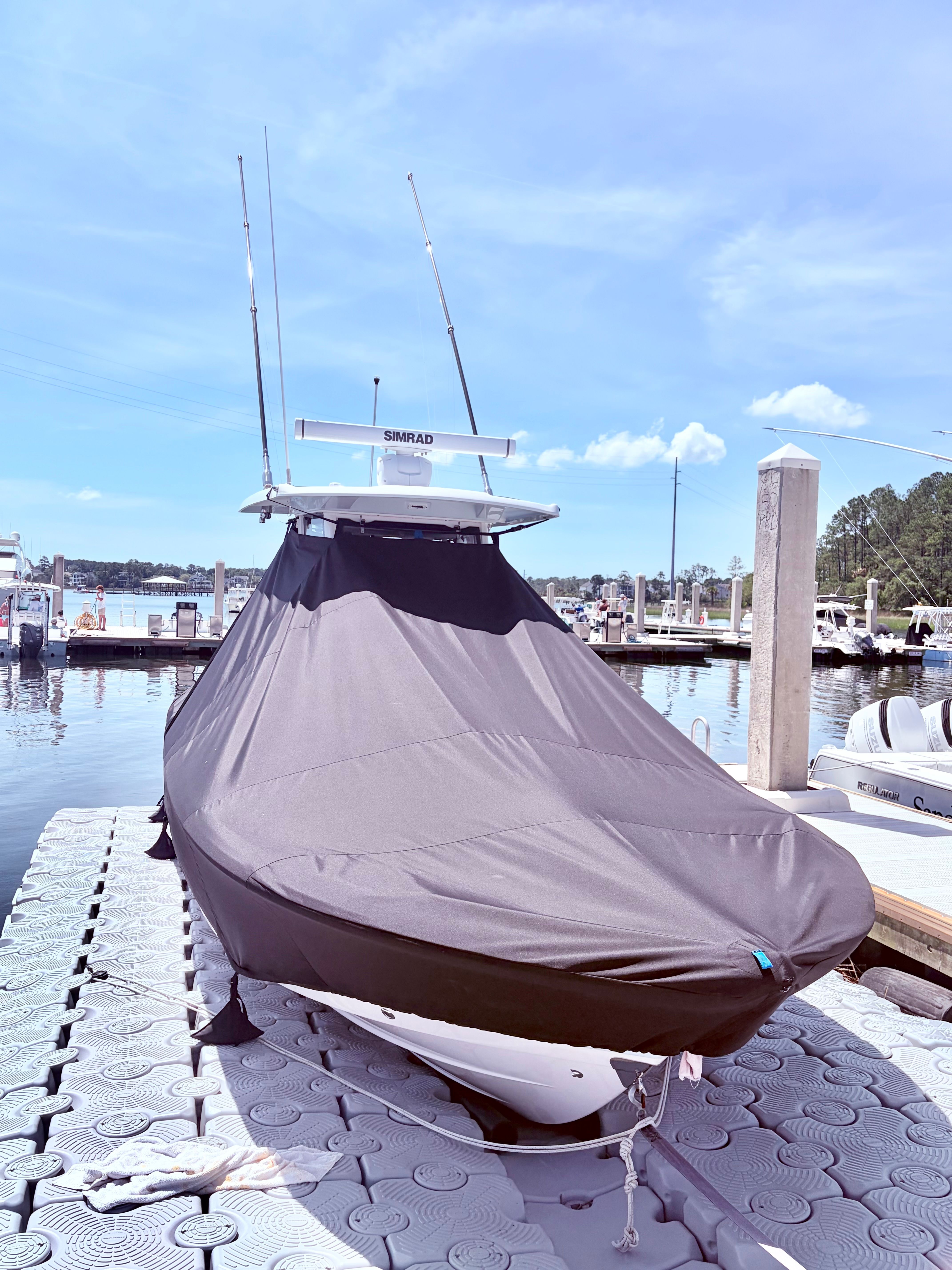 2025 Robalo 266 Cayman boat covered at dock.