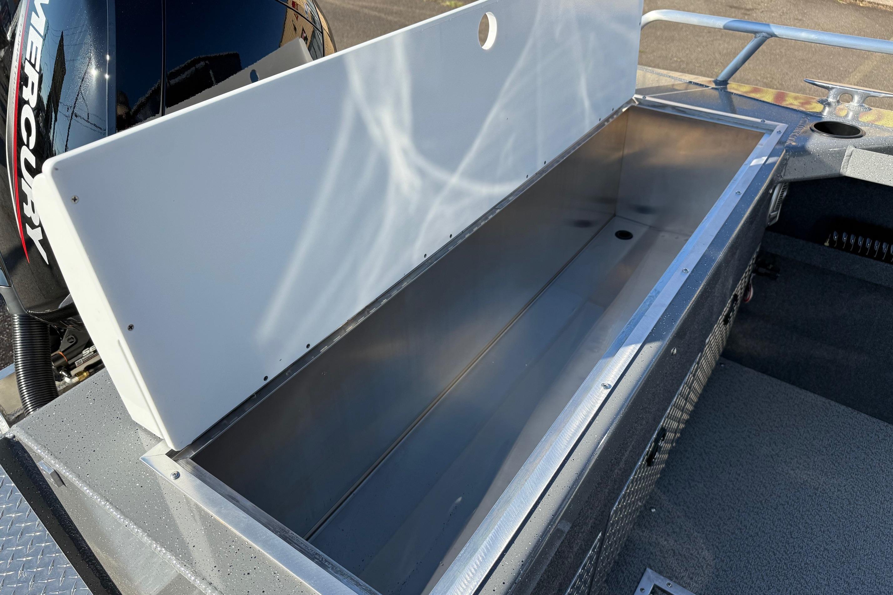 Open storage compartment on 2026 Thunder Jet 185 Luxor boat, featuring a Mercury engine.
