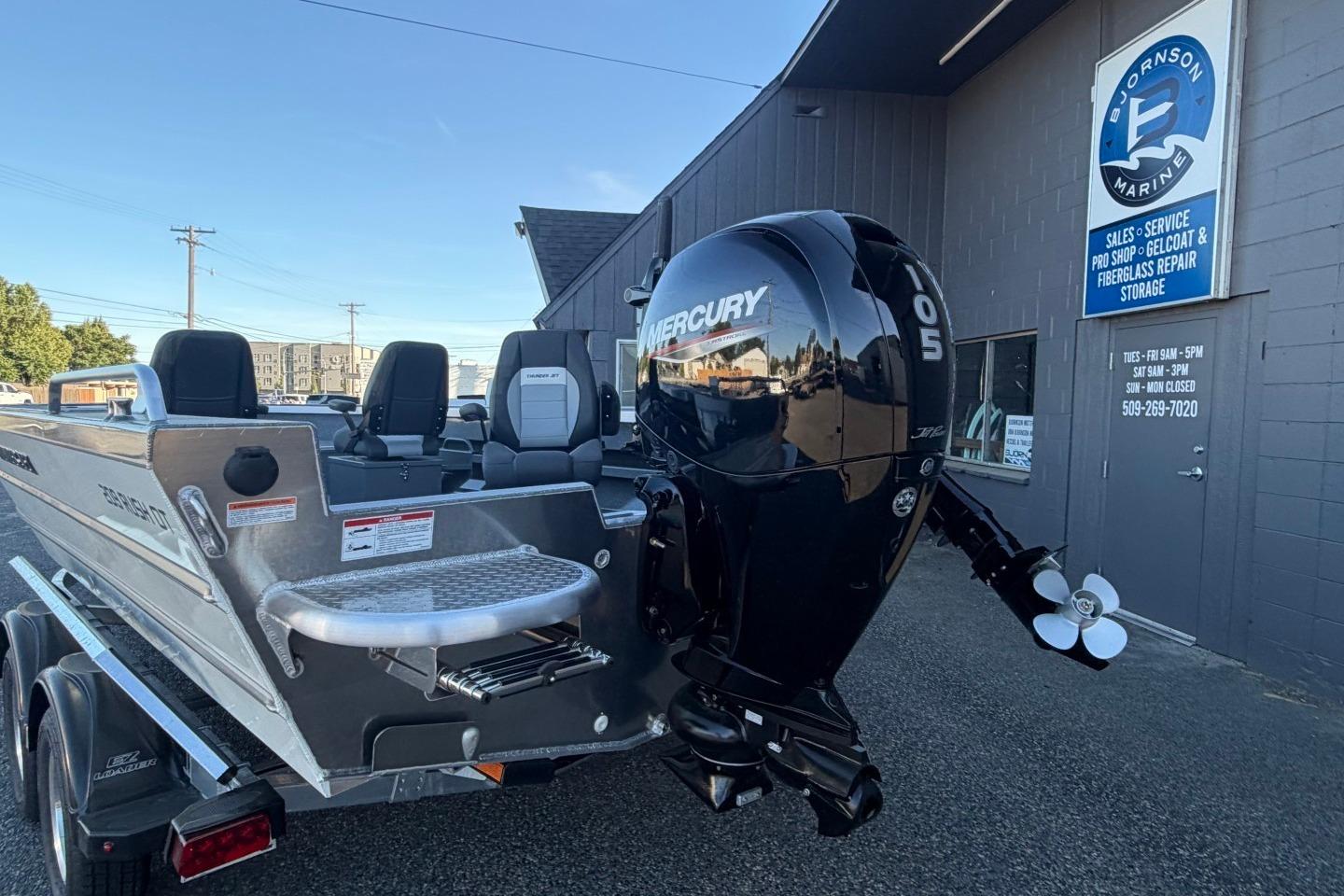 2026 Thunder Jet 209 Rush OT boat with Mercury outboard motor at dealership.
