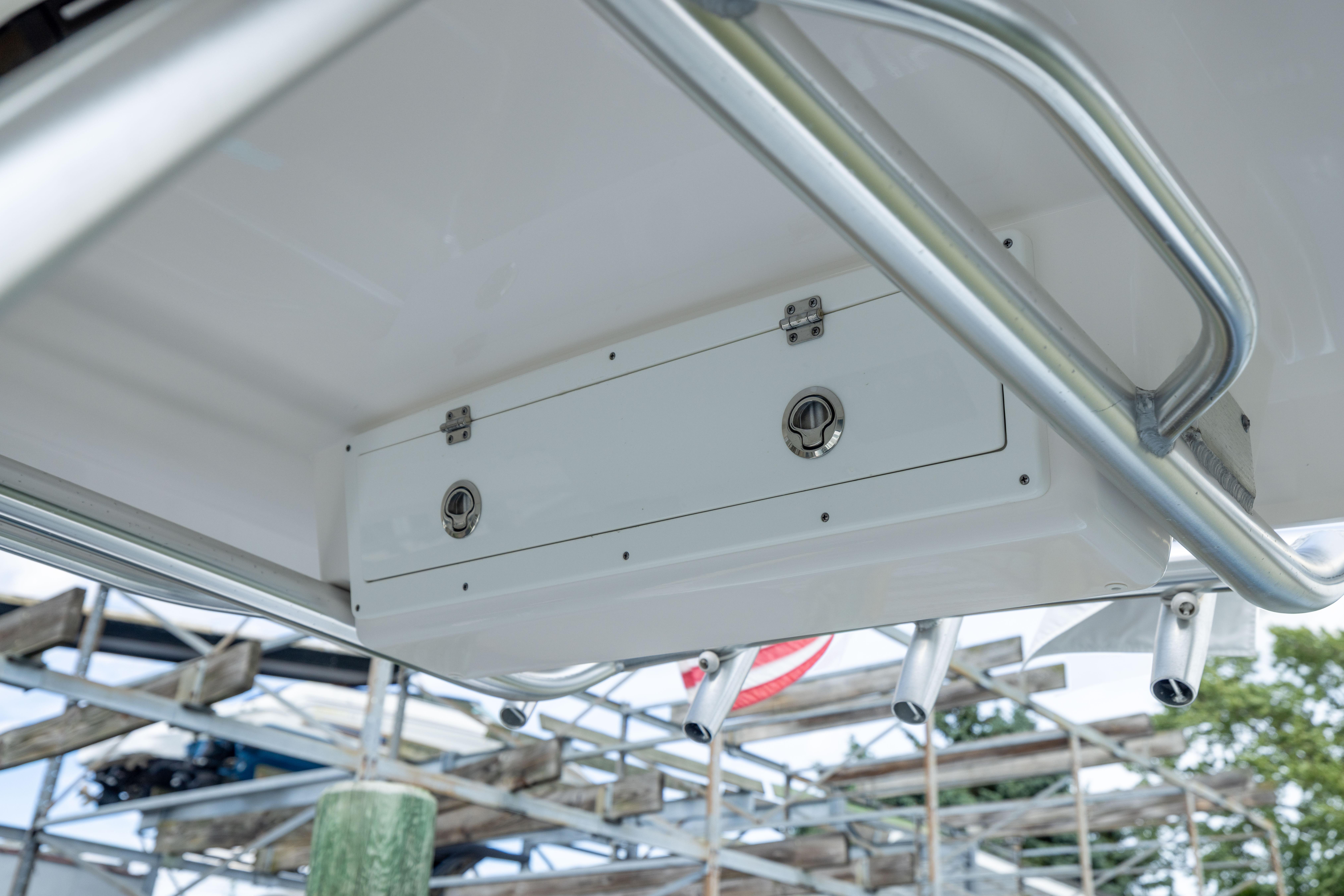 2023 Sea Fox 228 Commander boat storage compartment with stainless steel railing.