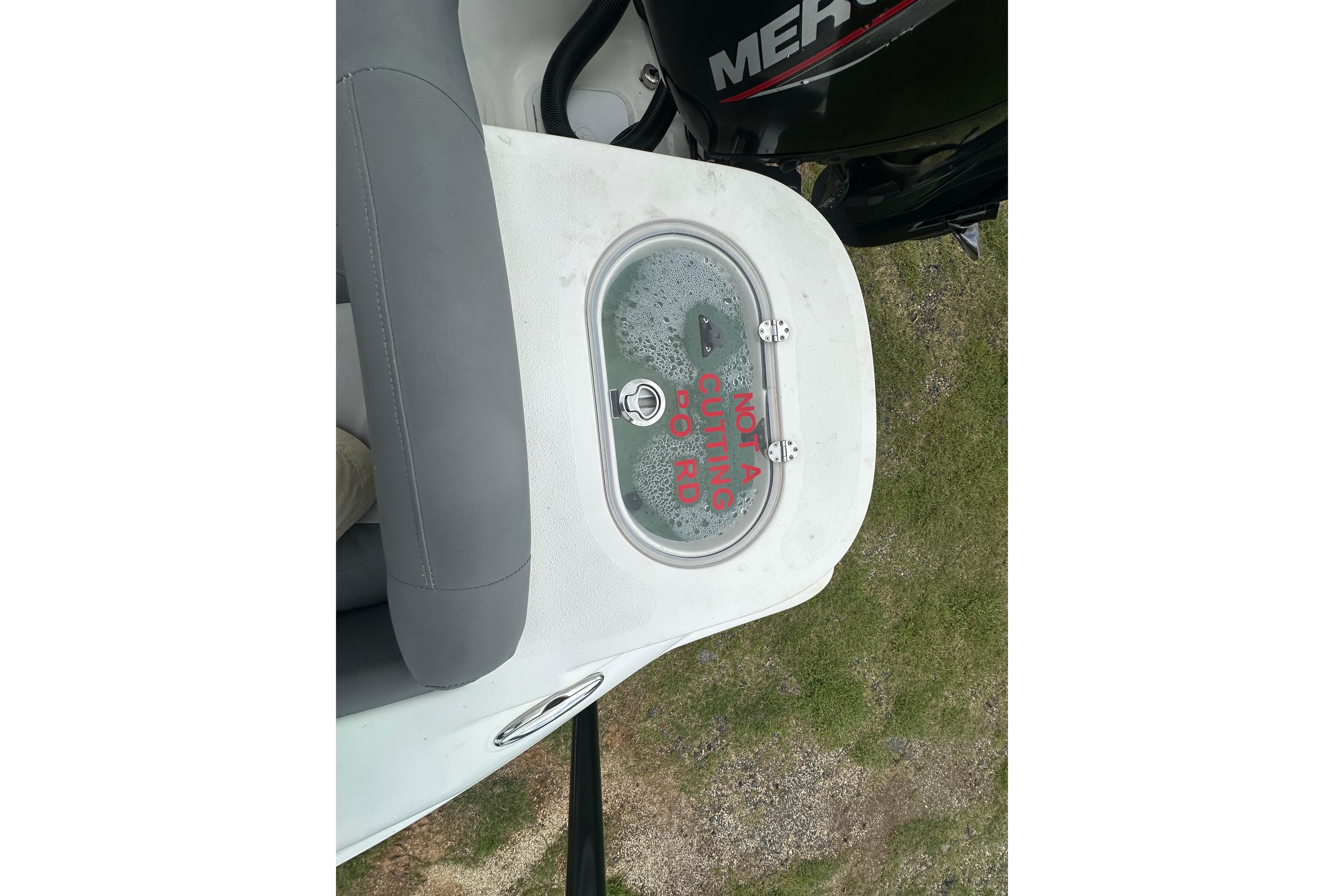 2023 NauticStar 2102 Legacy boat with "Not a Cutting Board" label on hatch.