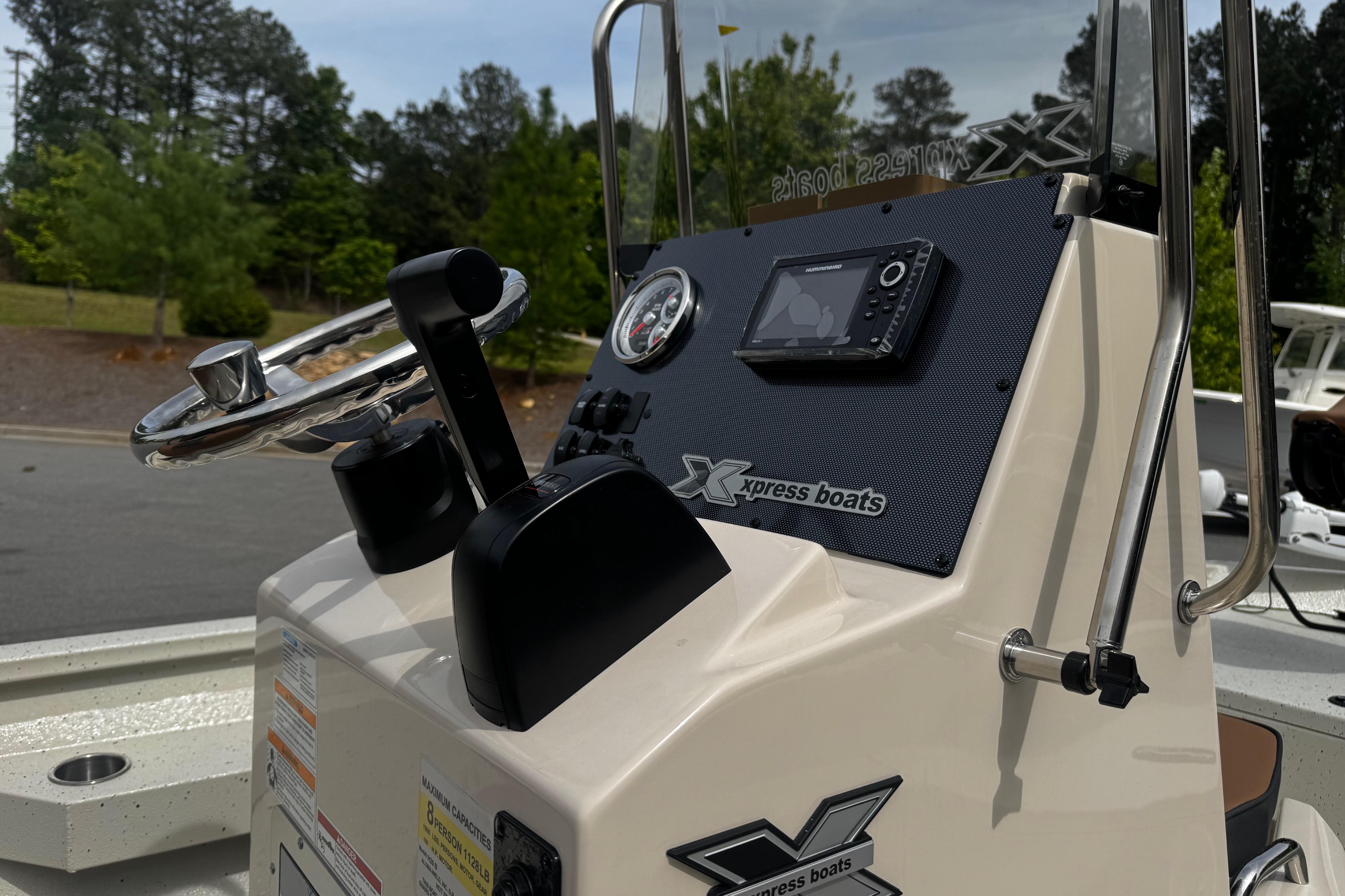 2026 Xpress H20B Bay boat console with steering wheel and navigation system.
