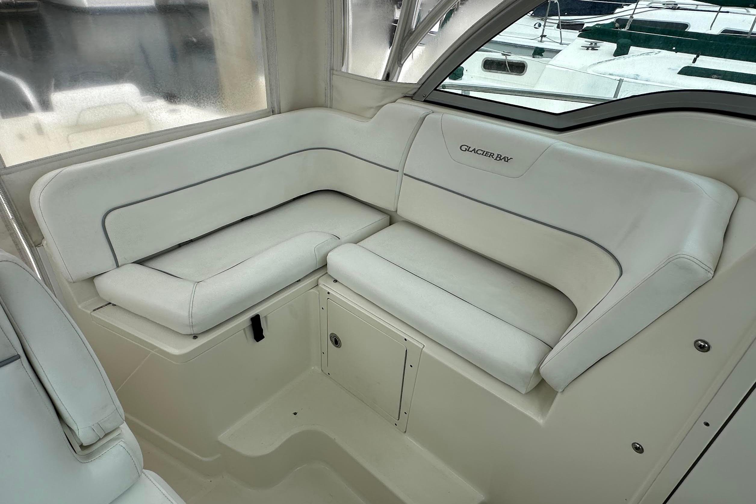 2013 Glacier Bay 2680 Coastal Runner interior with white cushioned seating.