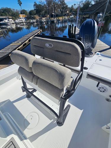 2026 Sea Hunt BX 22 BR boat with cushioned seating, docked by a serene waterfront.