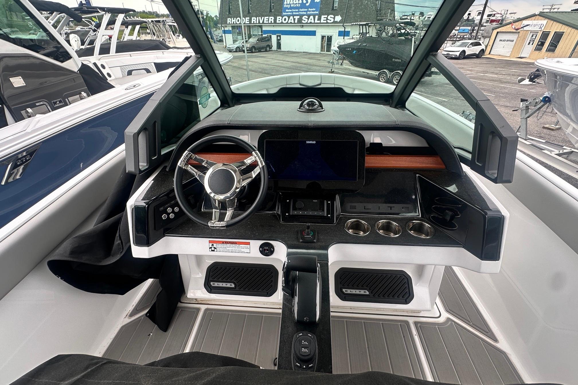2026 Monterey Elite 25 OB boat dashboard with modern steering and control panel.