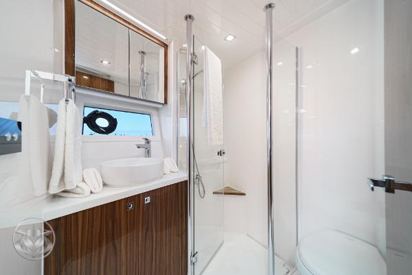 Luxurious bathroom in 2025 Riviera 645 SUV yacht with modern fixtures and elegant design.