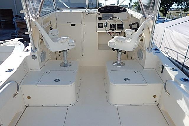 2003 World Cat 270 EC boat interior with dual captain chairs and steering console.