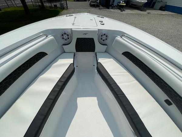2025 Tidewater 232 CC Adventure boat interior with white seating and speakers.