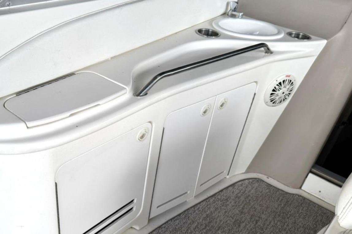 2000 Sea Ray 340 Sundancer boat interior with sink and storage cabinets.