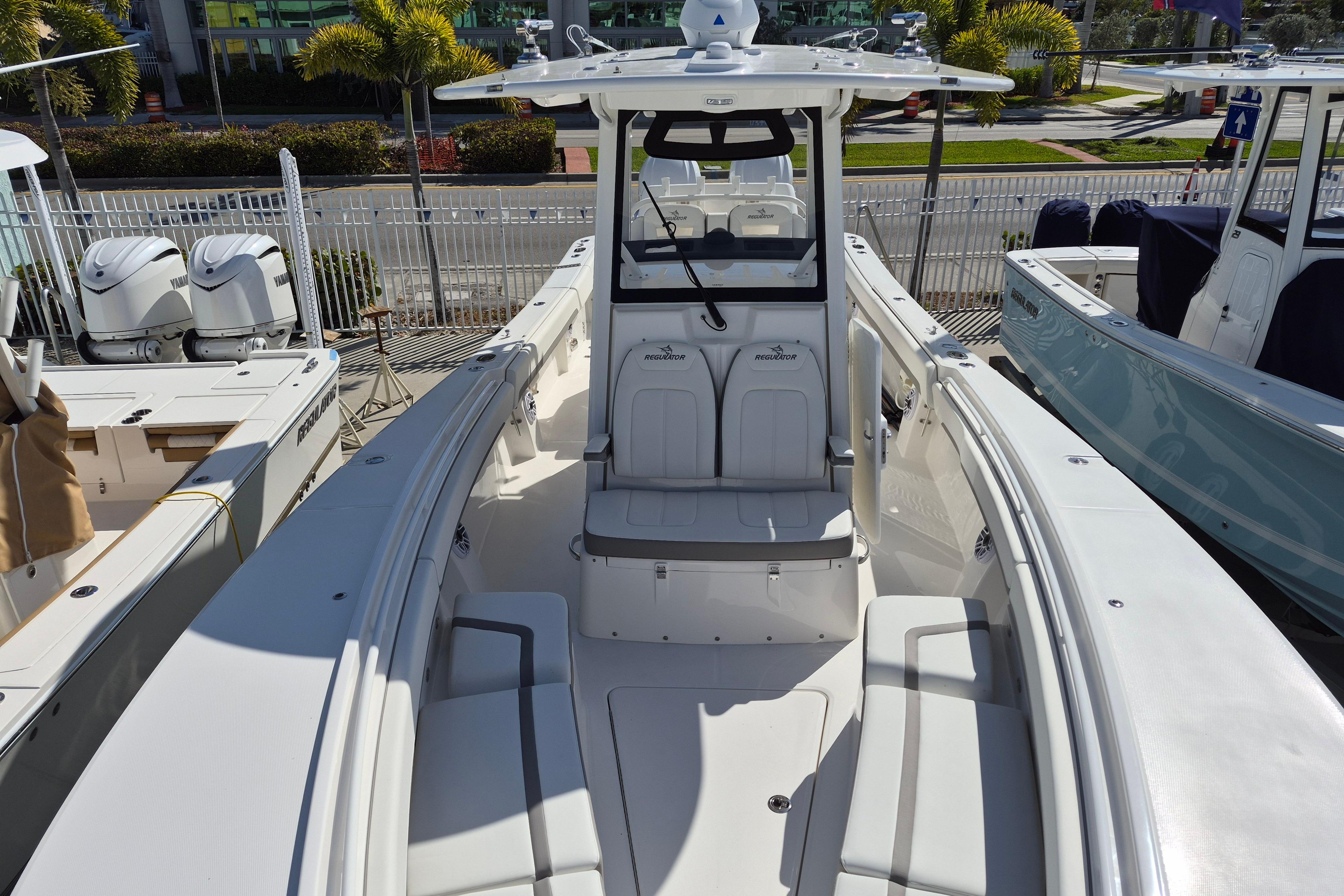 2026 Regulator 31 boat interior with seating and helm, docked with Yamaha engines.