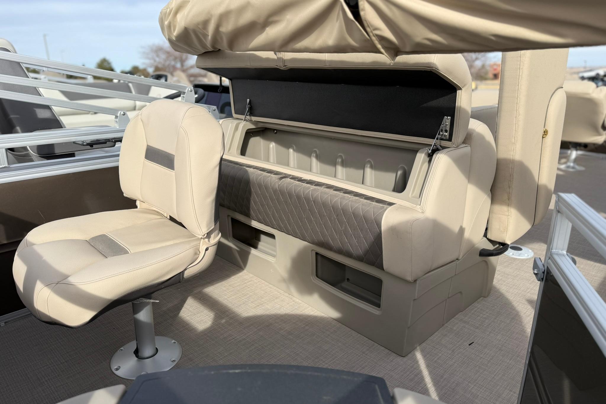 2025 Sun Tracker SportFish 20 DLX interior with beige seating and storage compartments.