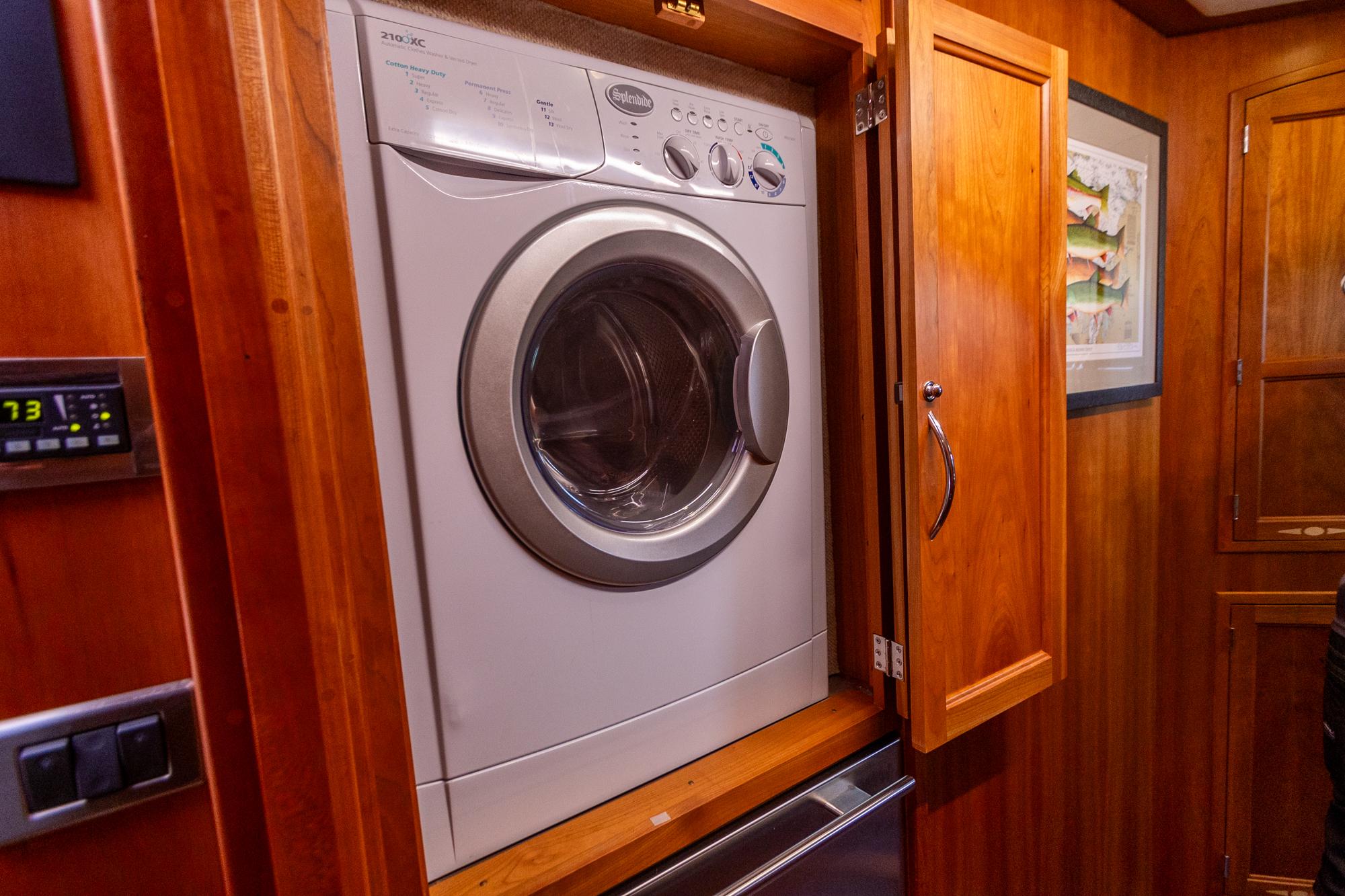 Washer in wooden cabinet on 2009 Sabre 52 Express yacht interior.
