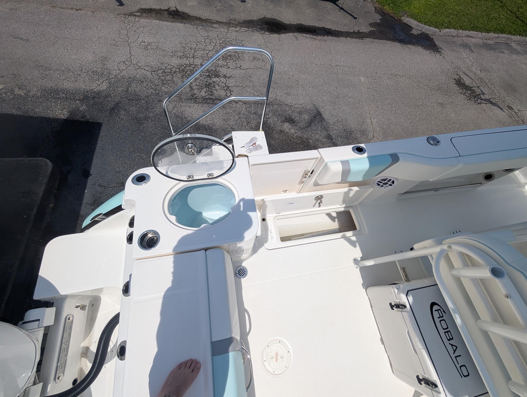 2025 Robalo R250 Center Console boat deck with seating and storage compartments.