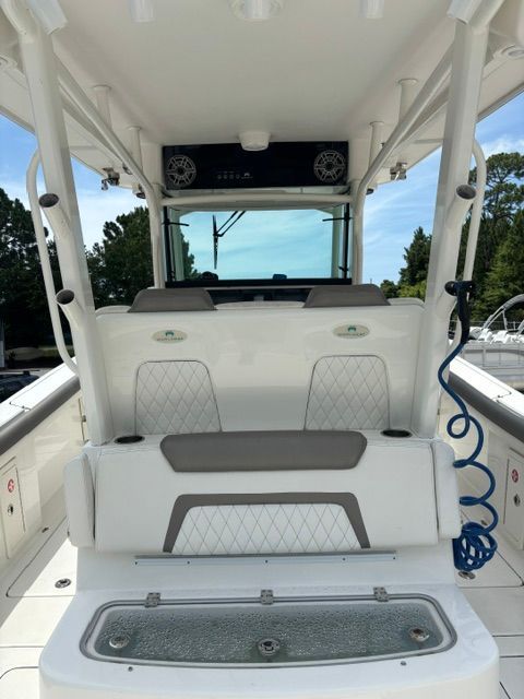 The boat features white upholstery and a modern helm console.