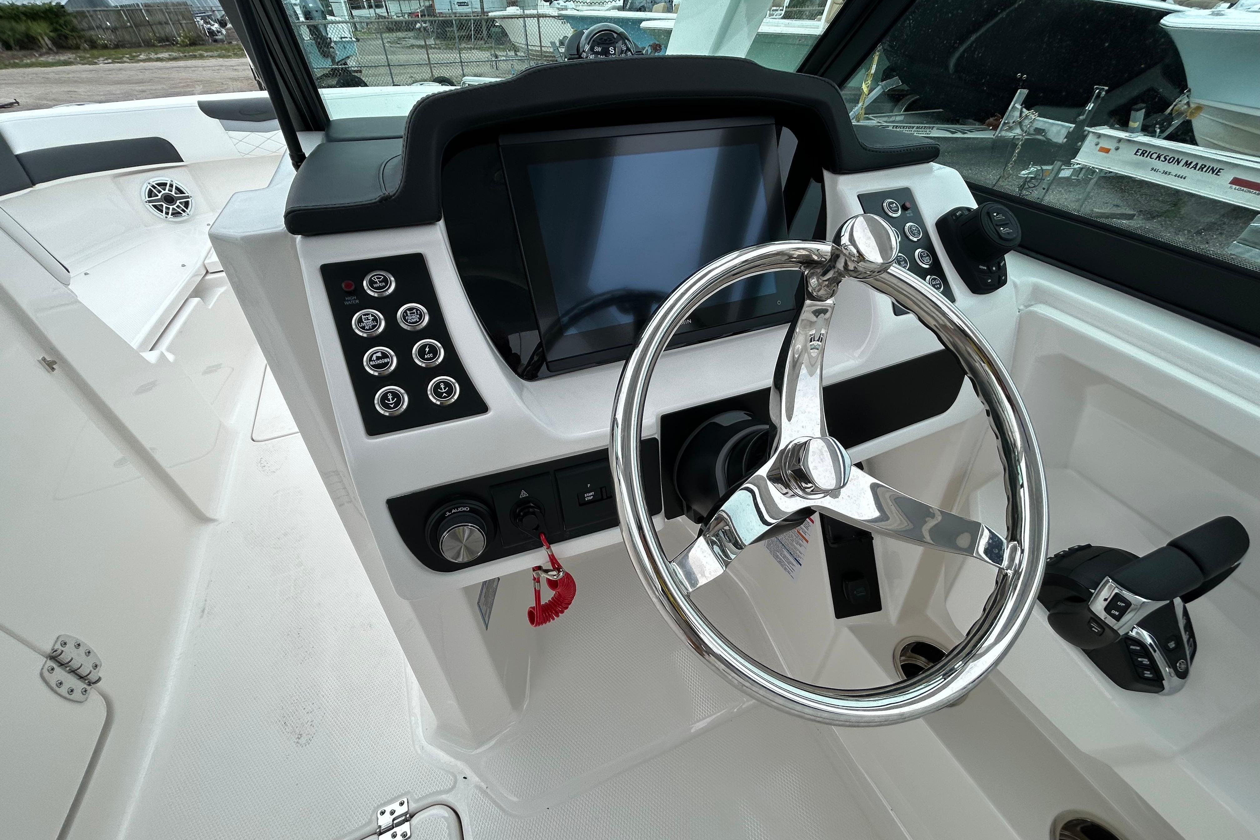 2026 Robalo R277 Dual Console helm with steering wheel and control panel.