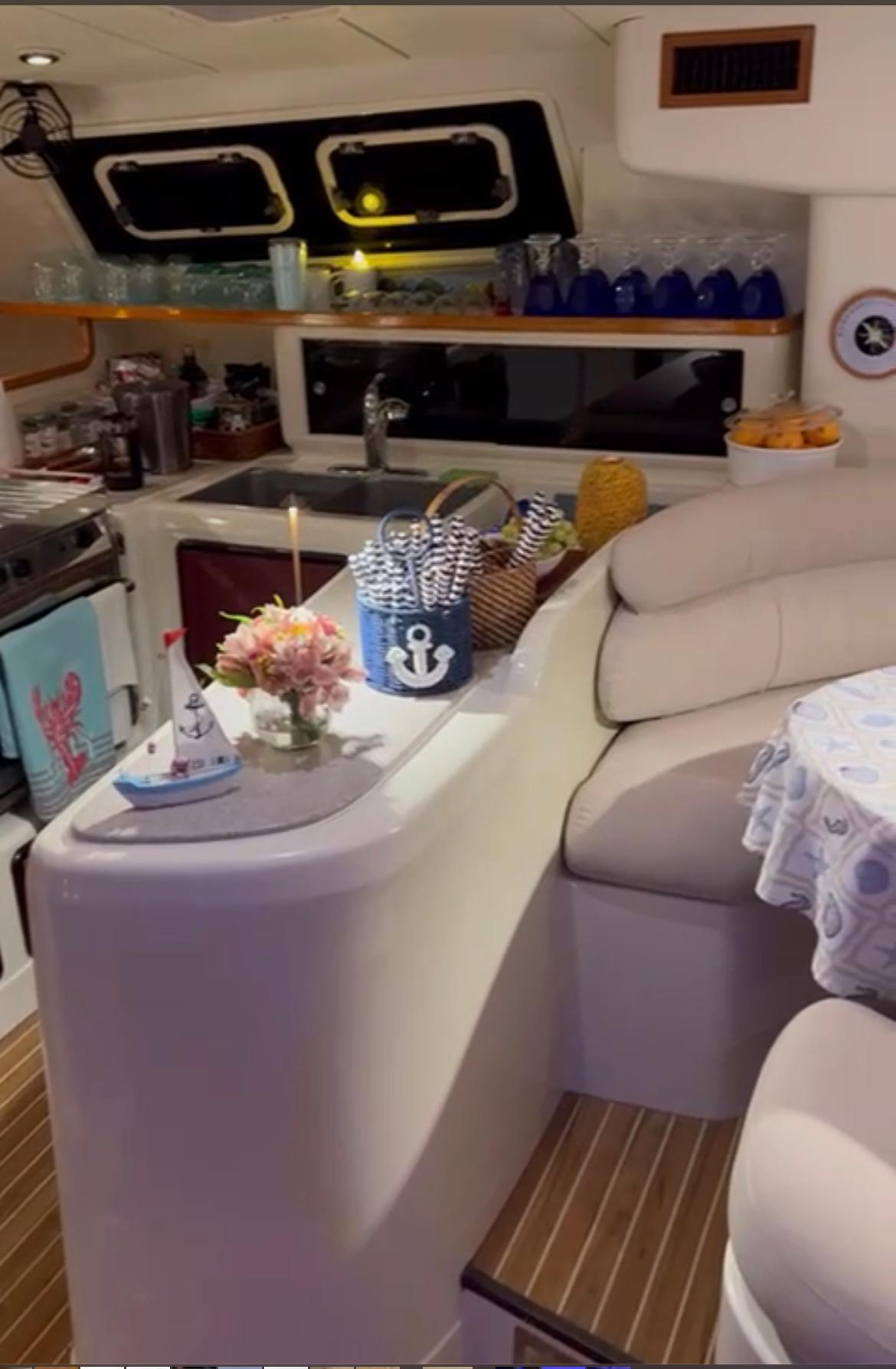 Interior of 2004 Leopard 47 yacht with cozy seating and nautical decor.