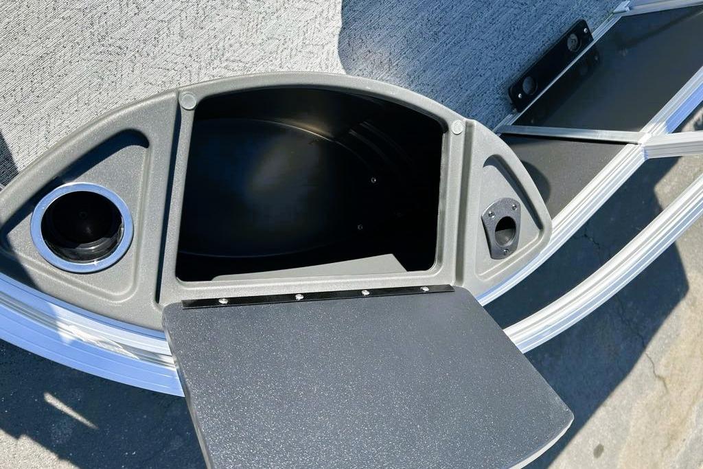 2026 Sun Tracker Bass Buggy 18 DLX storage compartment with cup holder and sleek design.