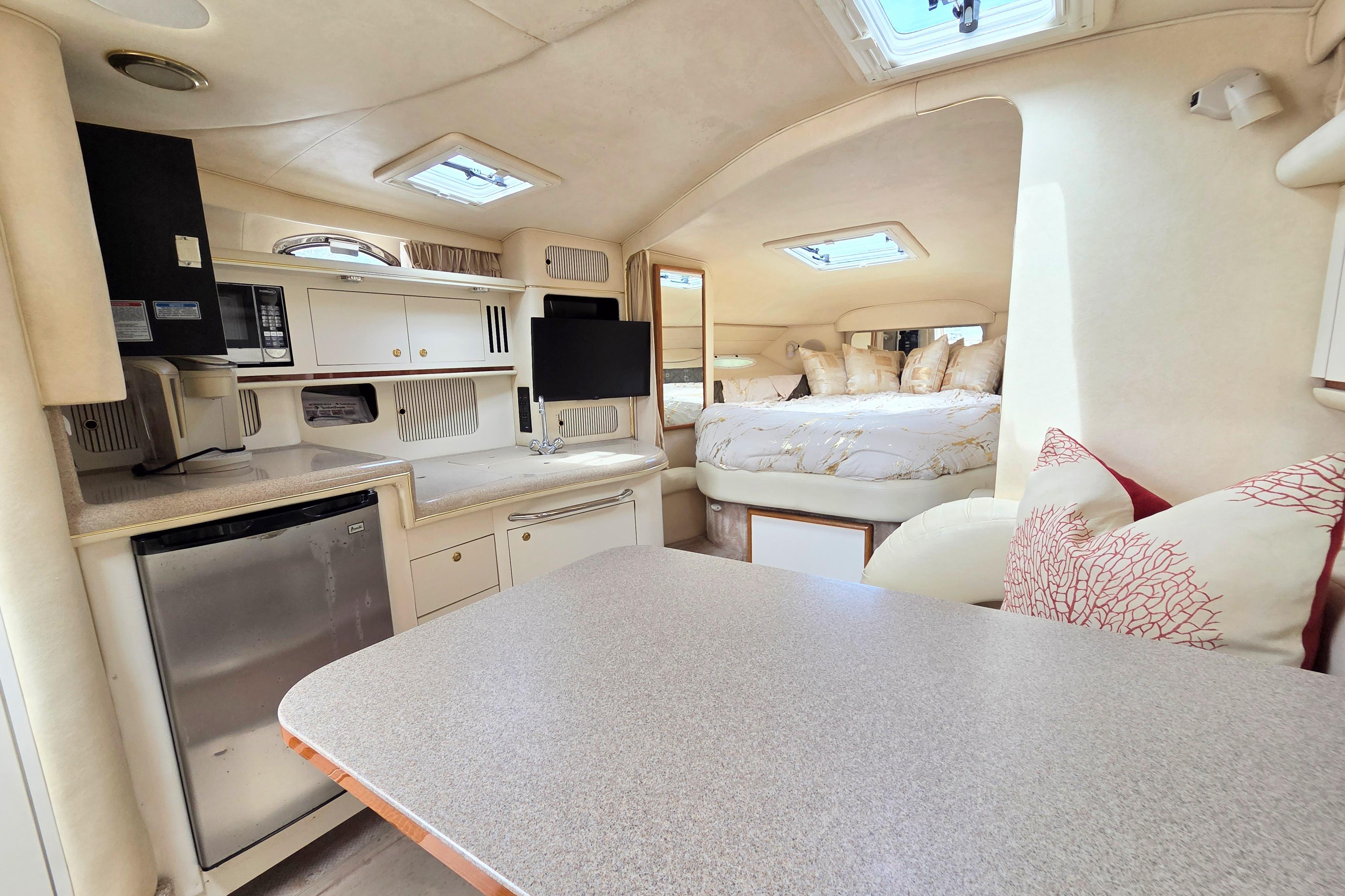 Interior of a 2000 Sea Ray 340 Sundancer yacht with cozy cabin and modern amenities.
