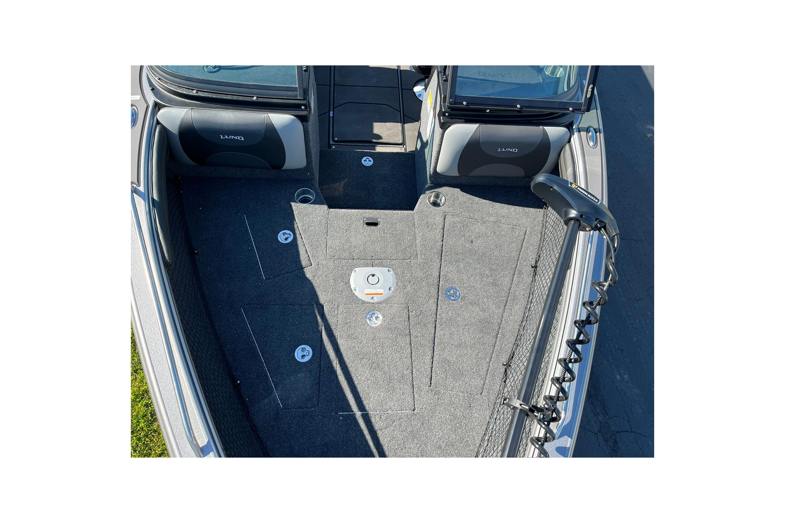 2026 Lund 2275 Baron boat interior with carpeted deck and seating.