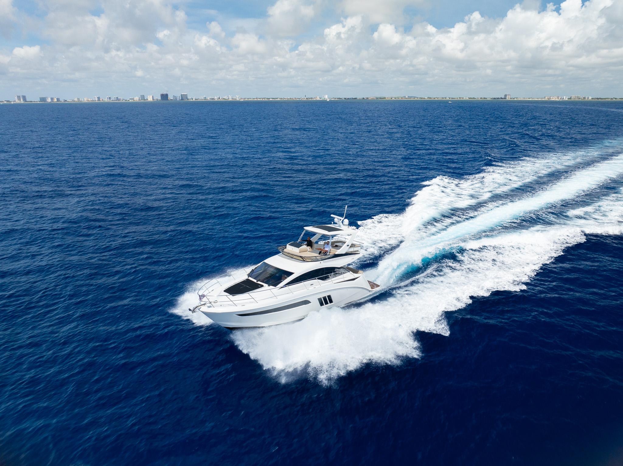 2016 Sea Ray 510 Fly yacht cruising on open blue ocean.