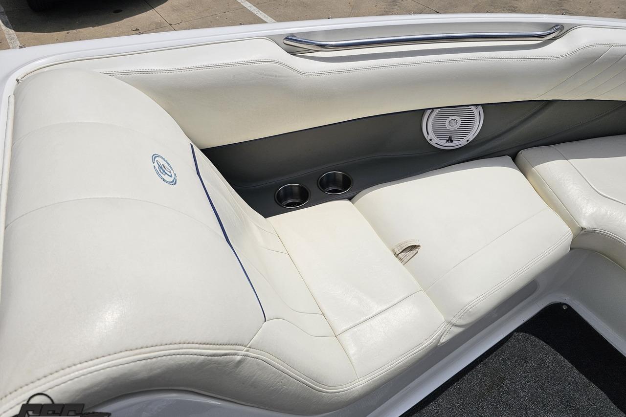 2010 Cobalt 232 WSS boat interior with white leather seating and speaker.