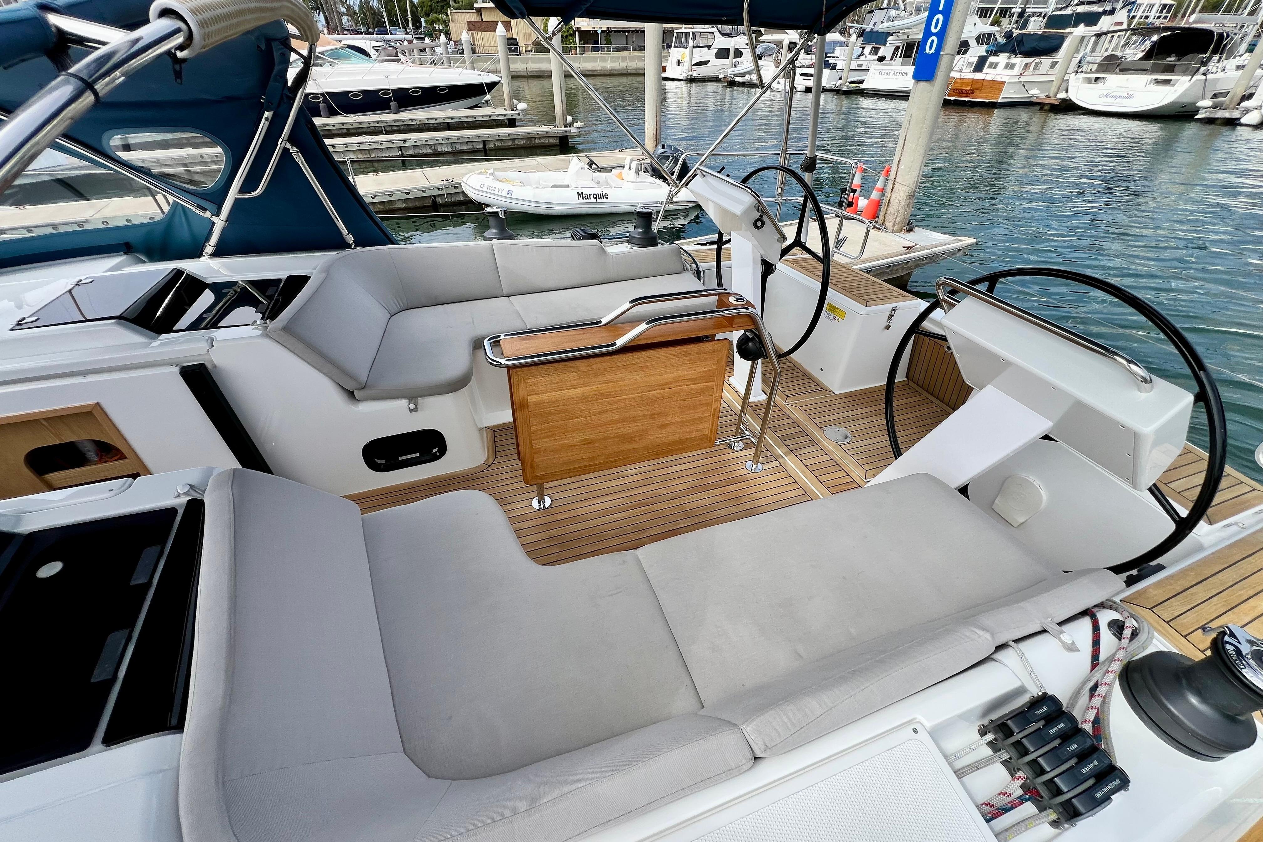 2016 Hanse 455 yacht cockpit with dual steering wheels and comfortable seating at marina.