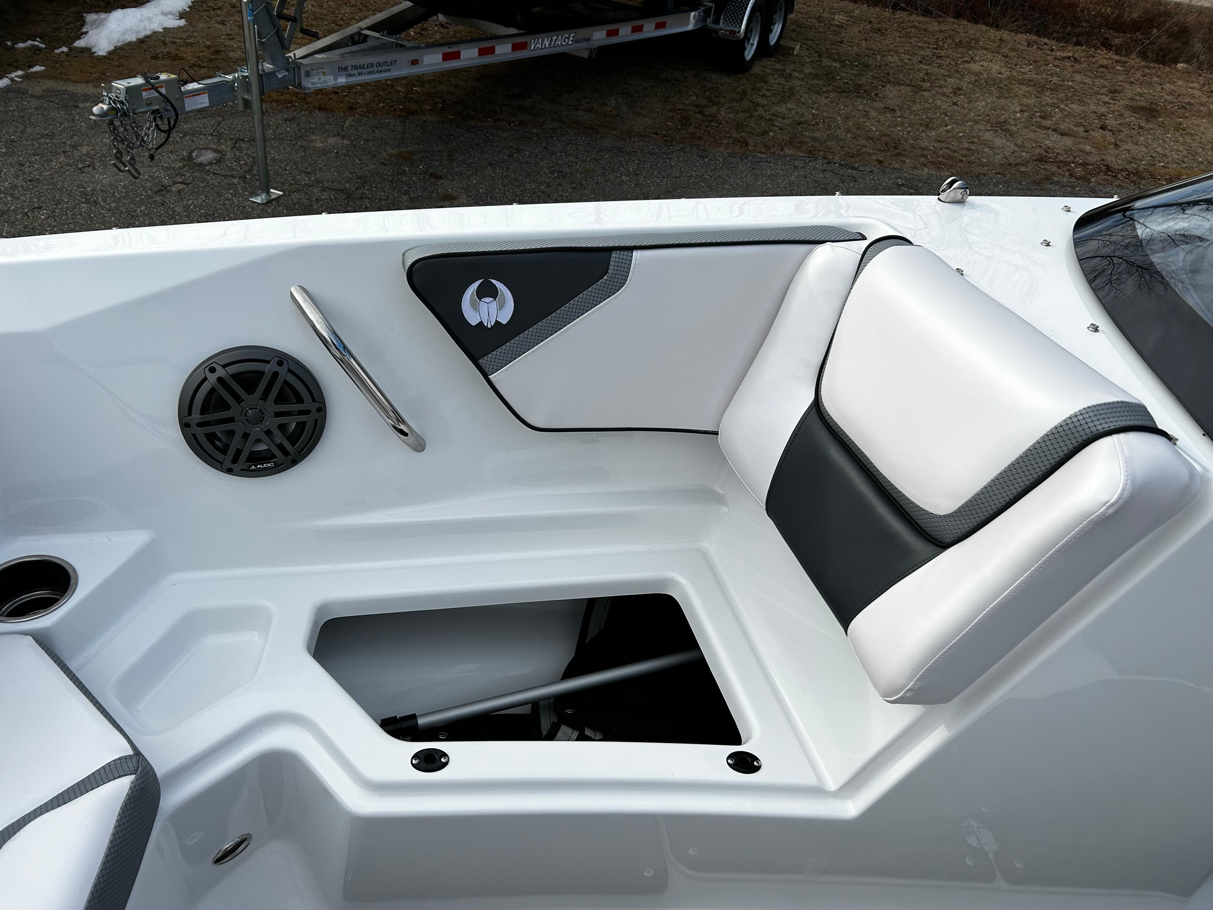 2024 Scarab 215 Wake LE boat interior with white and black seating and storage compartment.