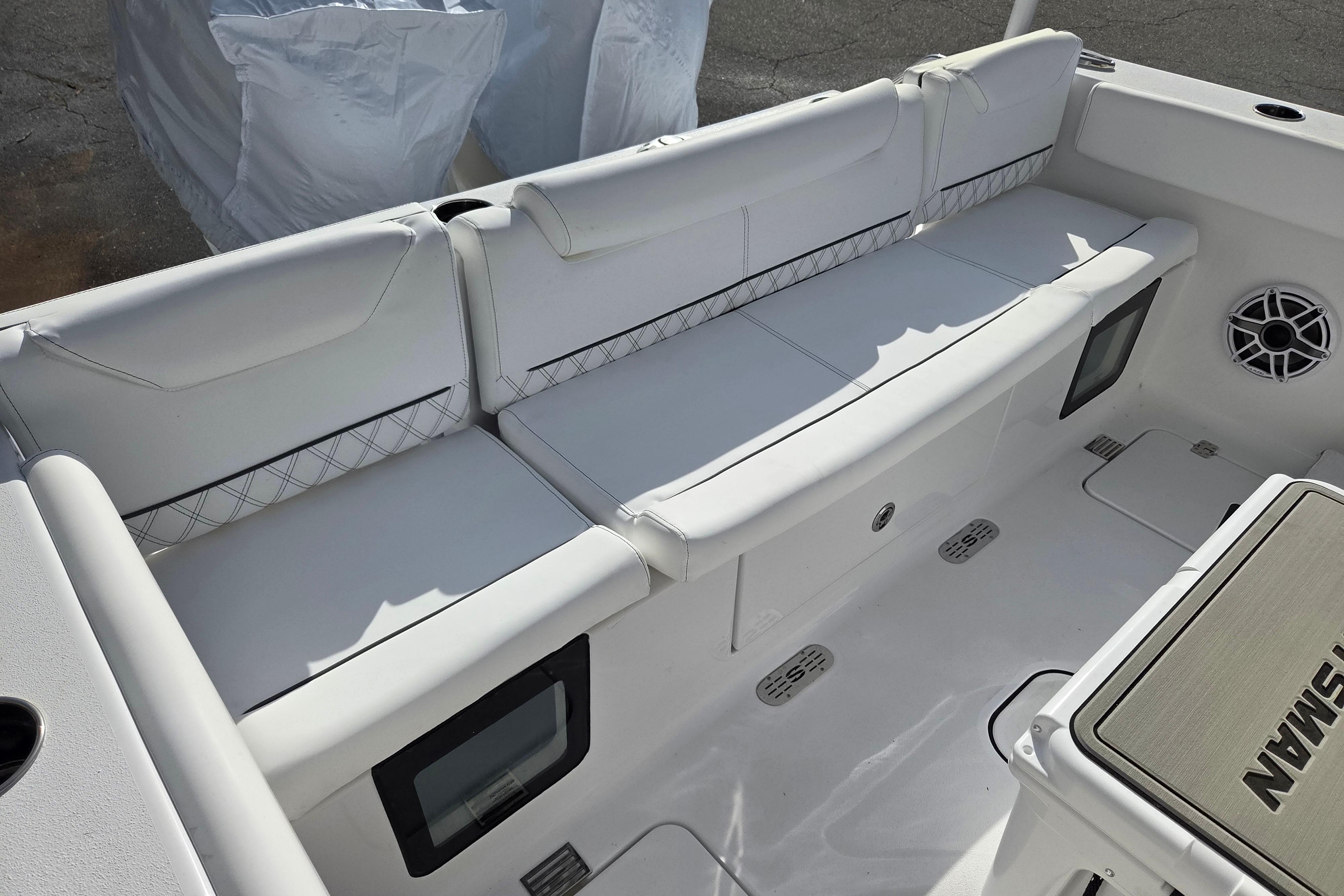 2026 Sportsman Heritage 261 Center Console boat interior with cushioned seating and speaker.