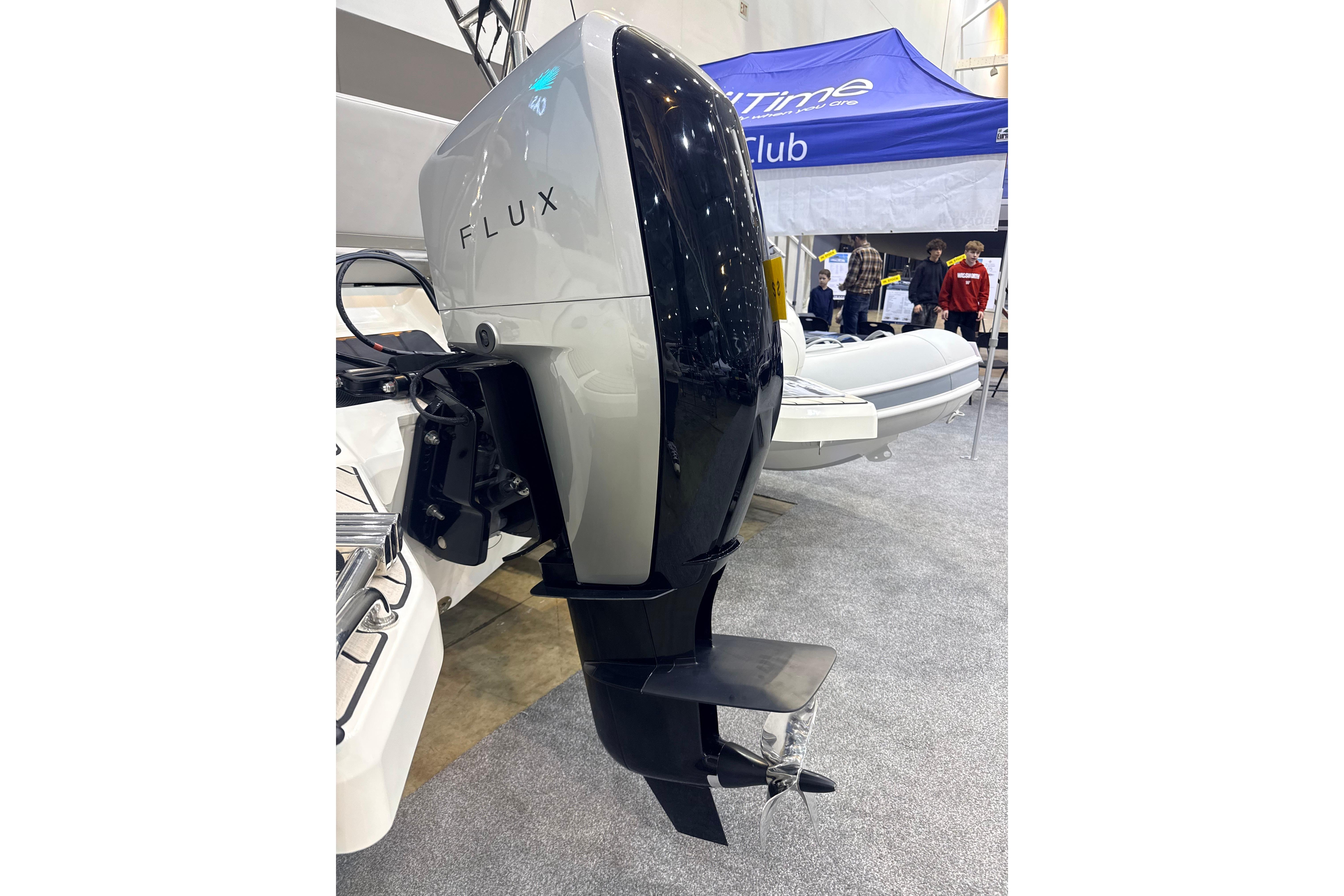 2025 Zodiac Medline 6.8 boat with Flux outboard motor at a marine exhibition.