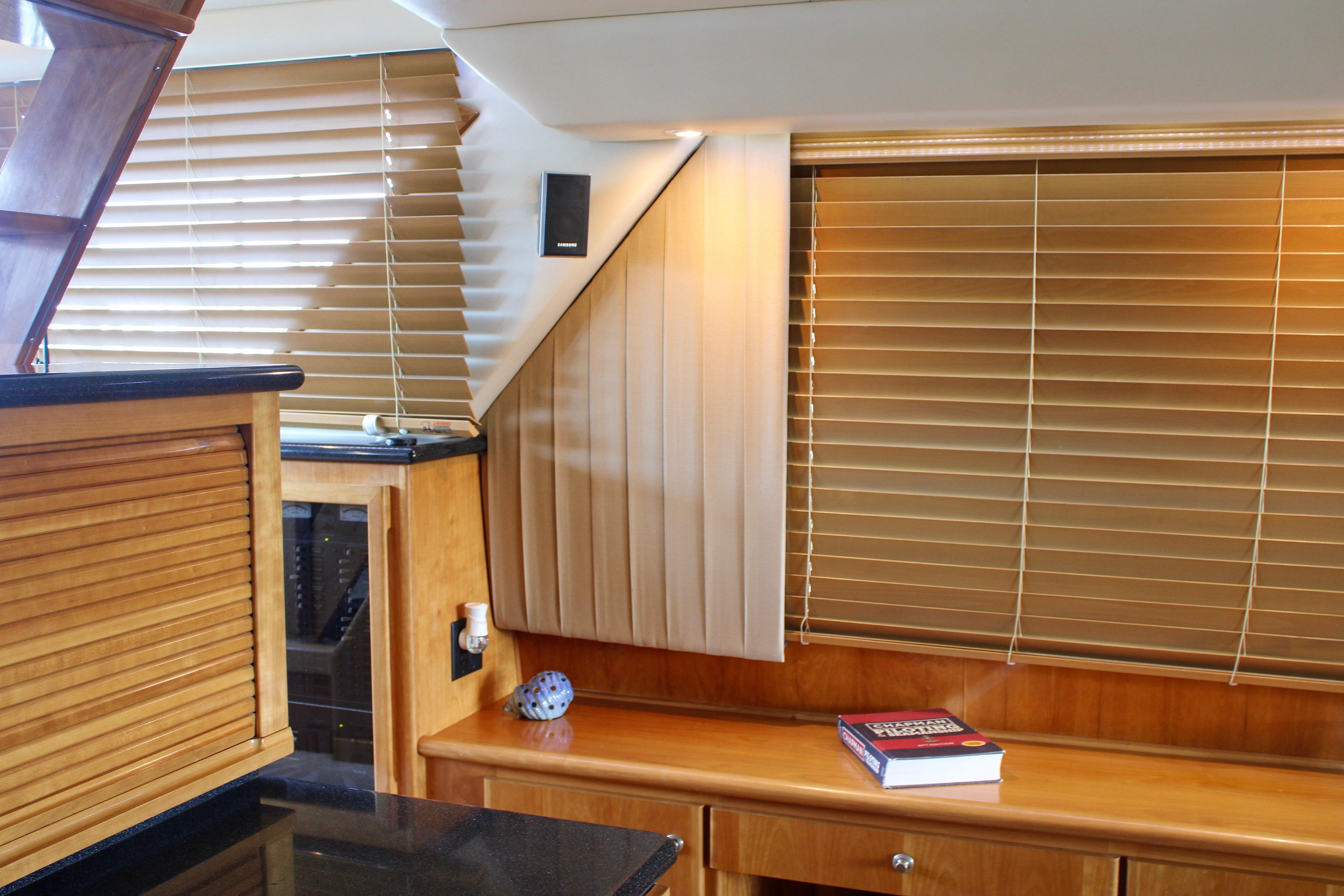 Luxurious interior of 2007 Navigator 5100 yacht with wooden blinds and elegant furnishings.